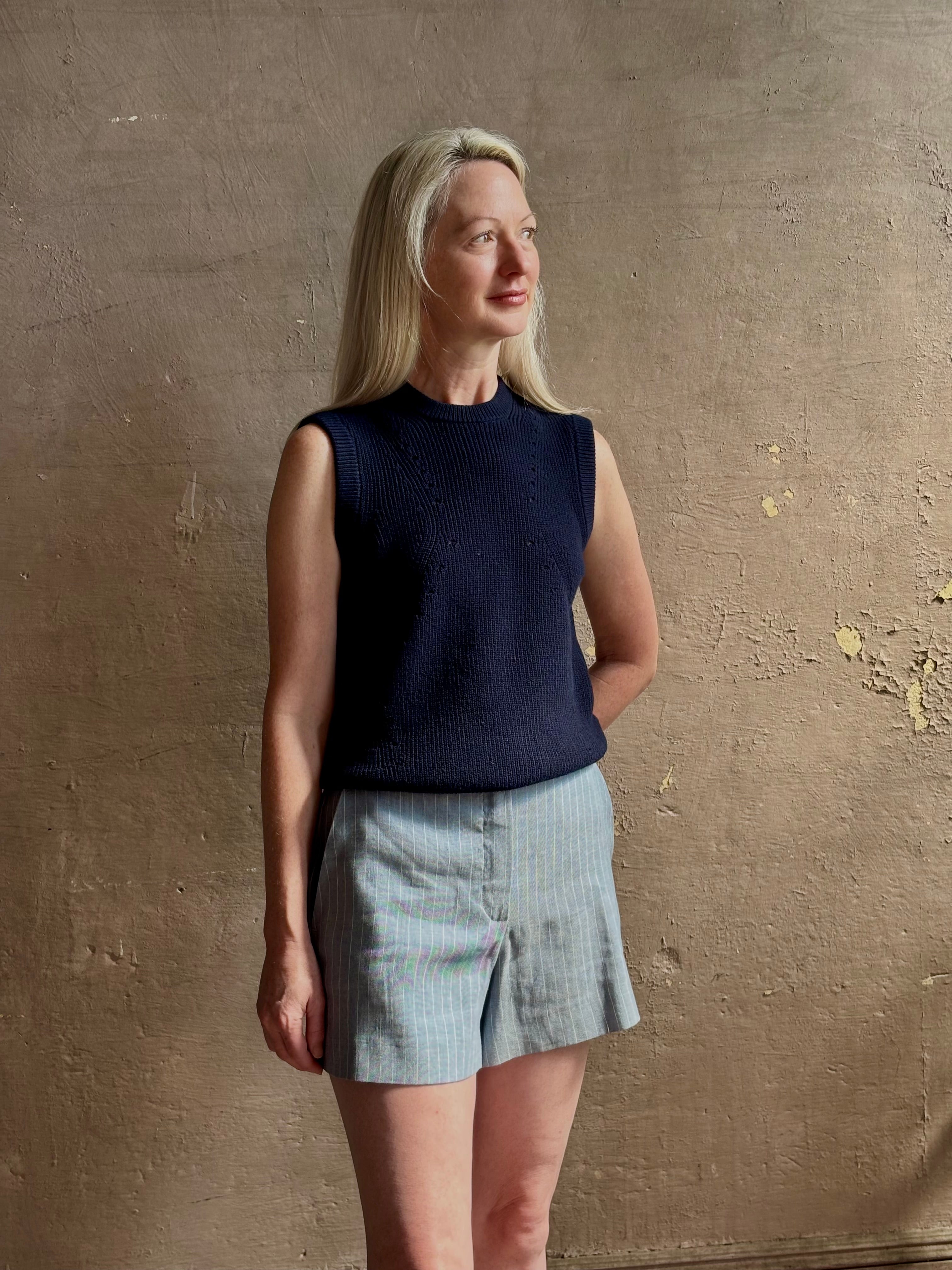 Woman wearing Vanessa Bruno Elisam elevated mid-rise tailored blue and white pinstripe short naturally breathable