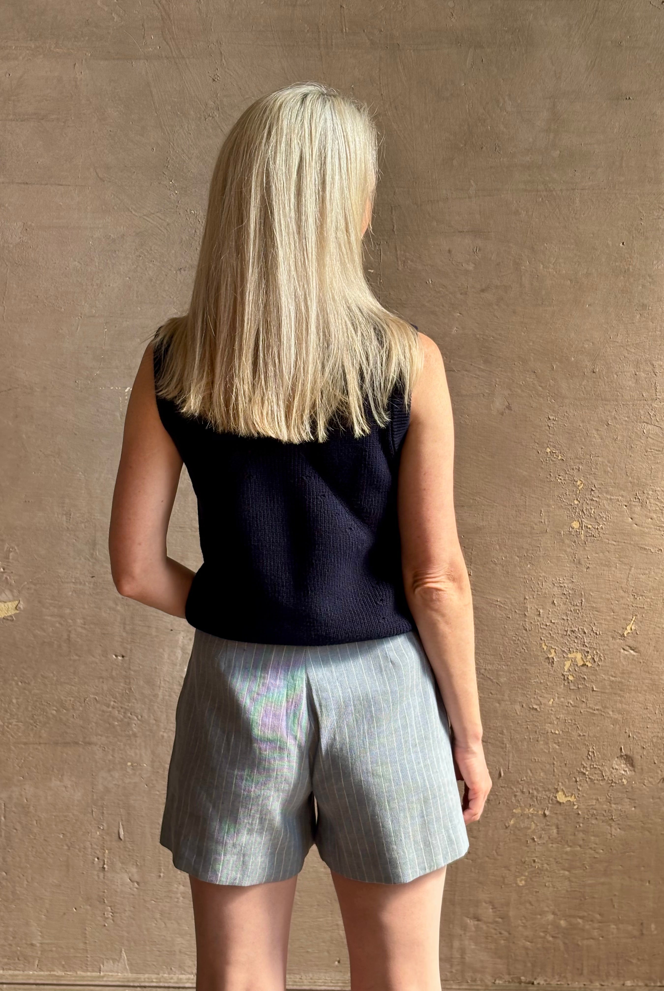 Woman wearing Vanessa Bruno Elisam elevated mid-rise tailored blue and white pinstripe short naturally breathable