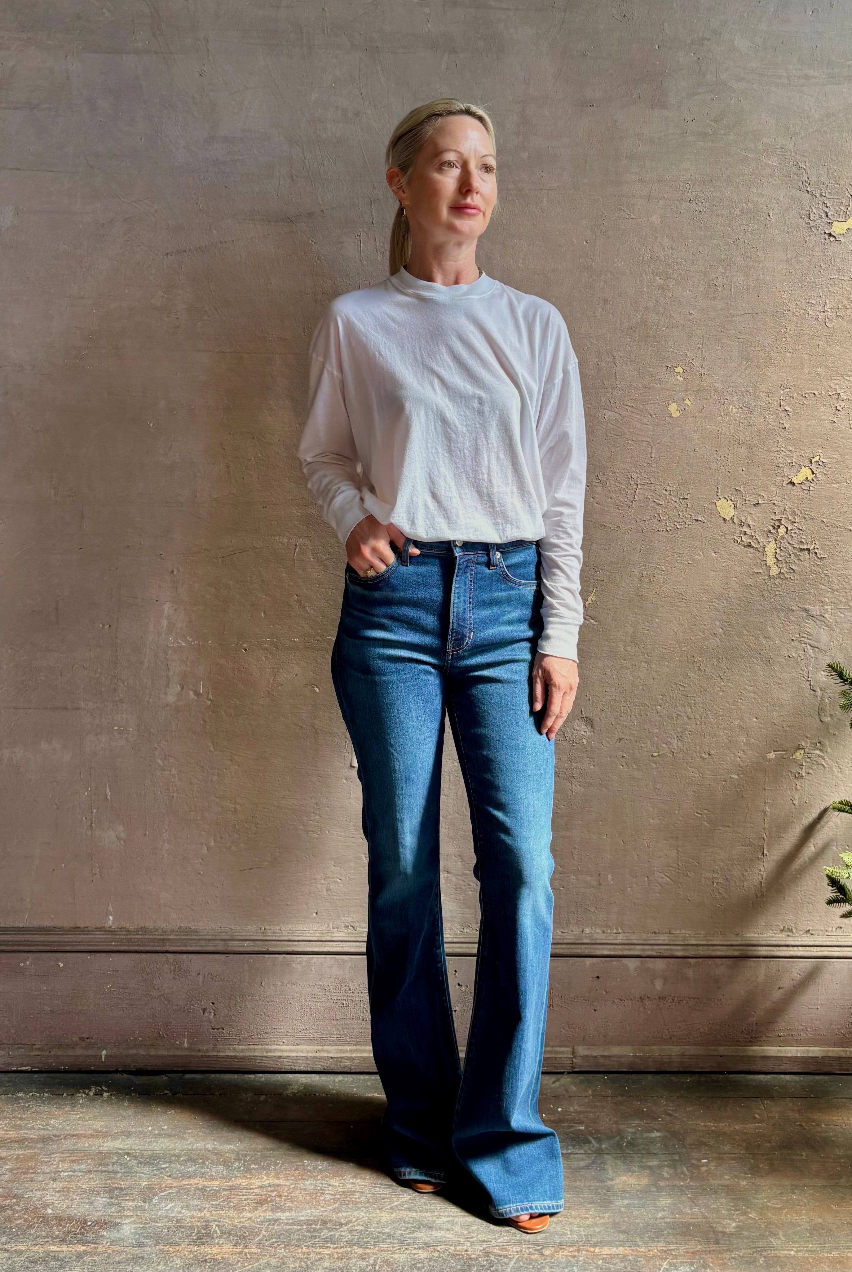 Mature woman wearing VERONICA BEARD BEVERLY JEANS medium wash Women's Cotton Blend High-Rise Flared Leg