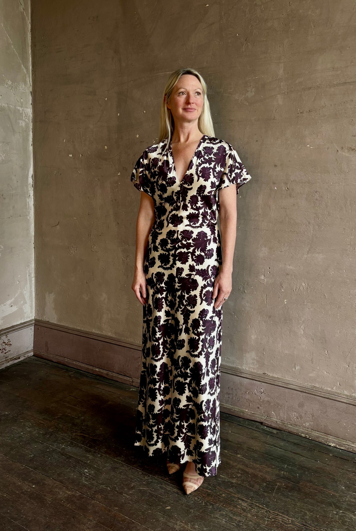 Mature woman wearing designer Veronica Beard V-Neck Redgrave Dress in Ecru Multi sheath maxi purple floral print Elongating, occasion-ready