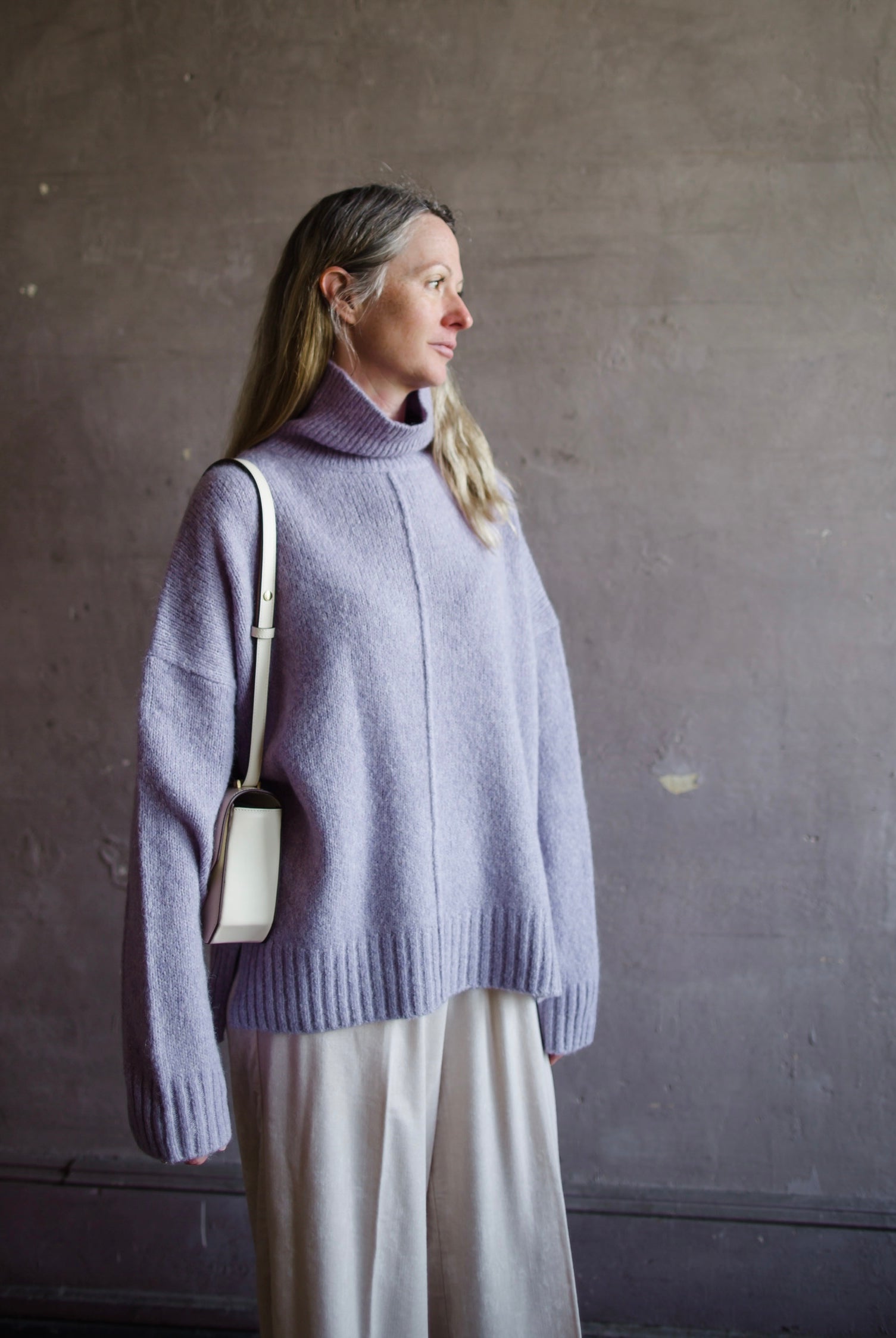 Image featuring a woman wearing the Balade yack, alpaca & wool sweater by Vanessa Bruno with a high neckline with a front seam and oversized fit in lilac color.