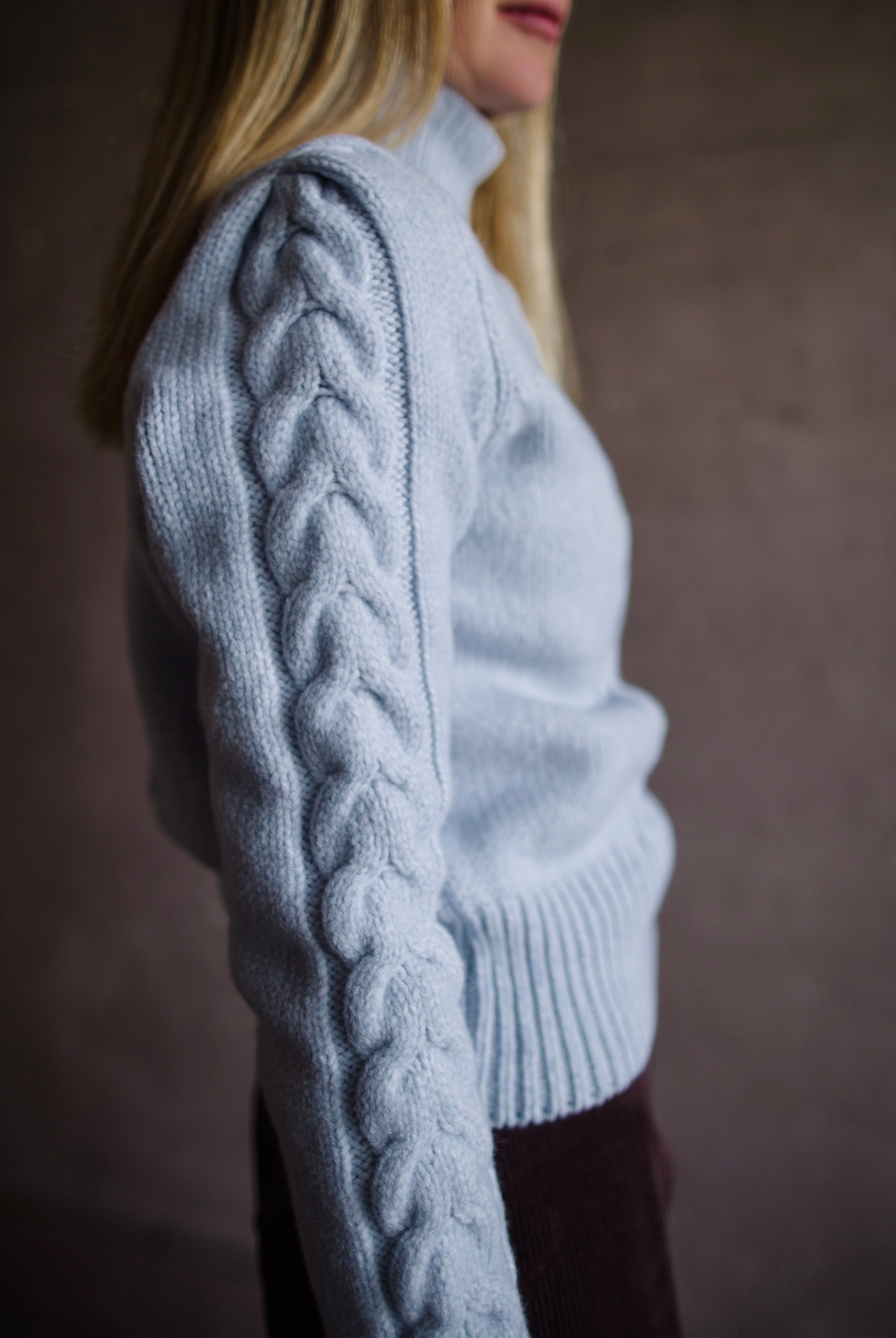 Side view of Woman wearing Vanessa Bruno dabatha cable knit turtleneck sweater in shade azure merino wool blend