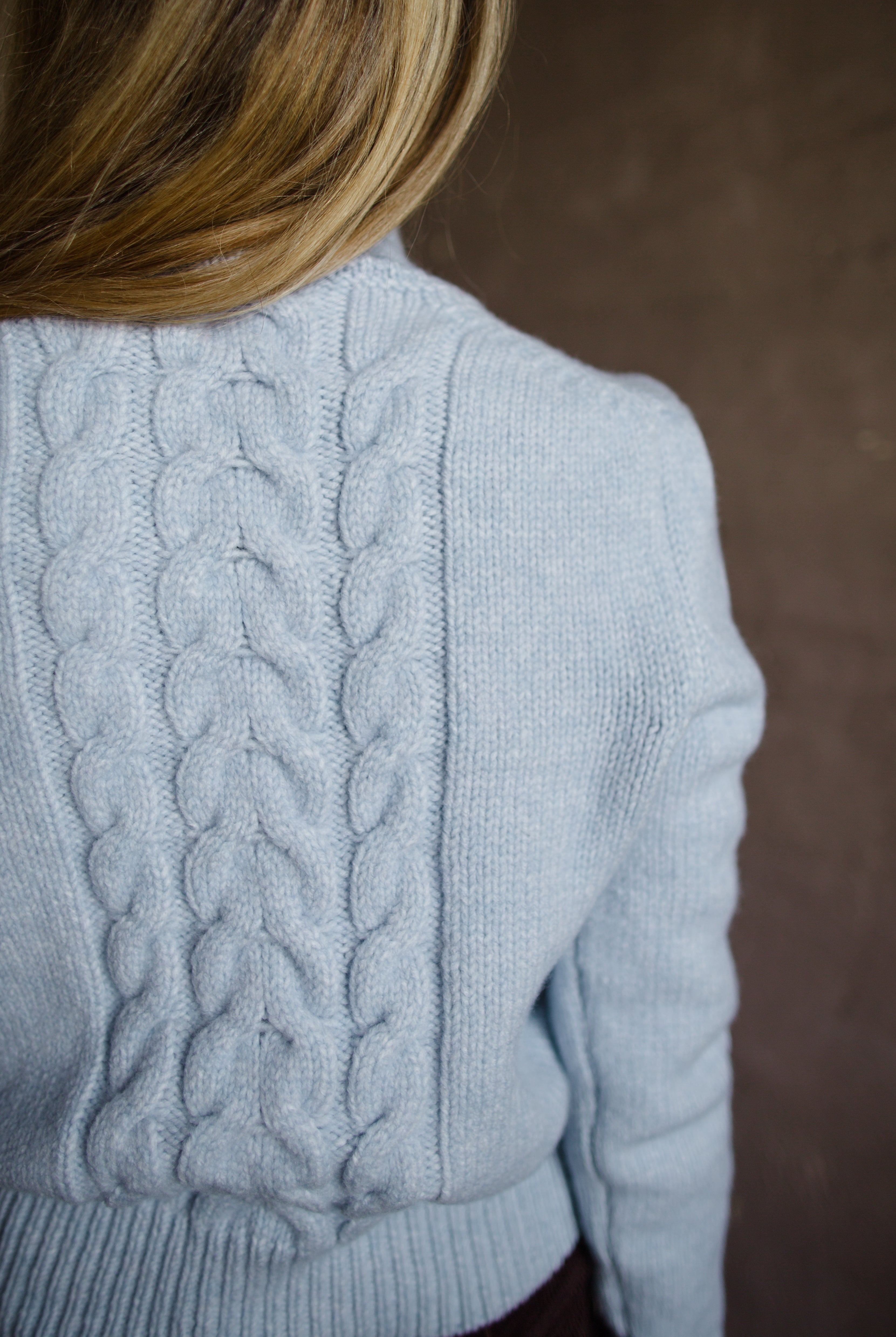 Back view of Woman wearing Vanessa Bruno dabatha cable knit turtleneck sweater in shade azure merino wool blend