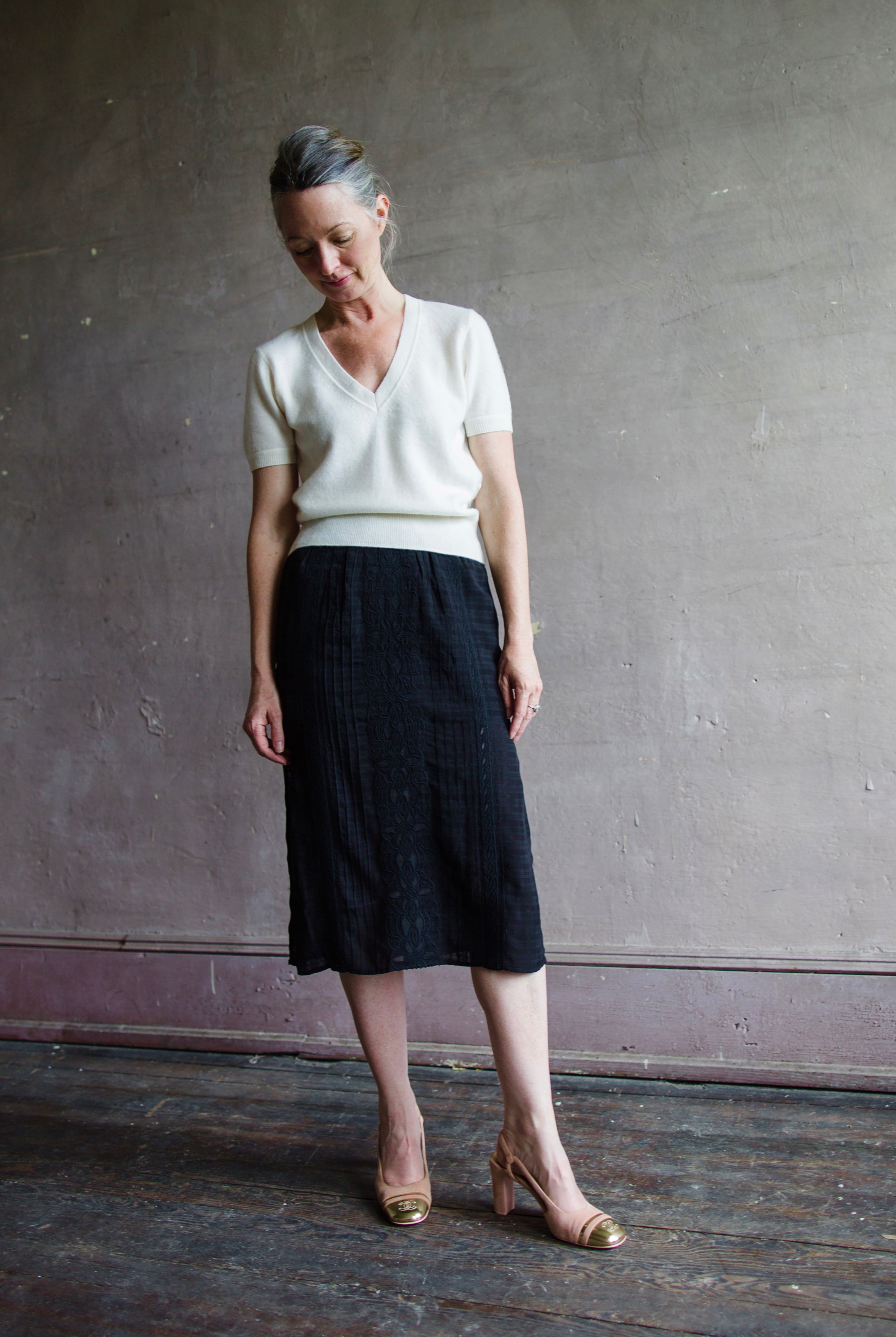 Image featuring a woman wearing the Dori skirt by Vanessa Bruno with a semi-sheer jacquard viscose textured and layered fit, side slits and an elastic waist in black.