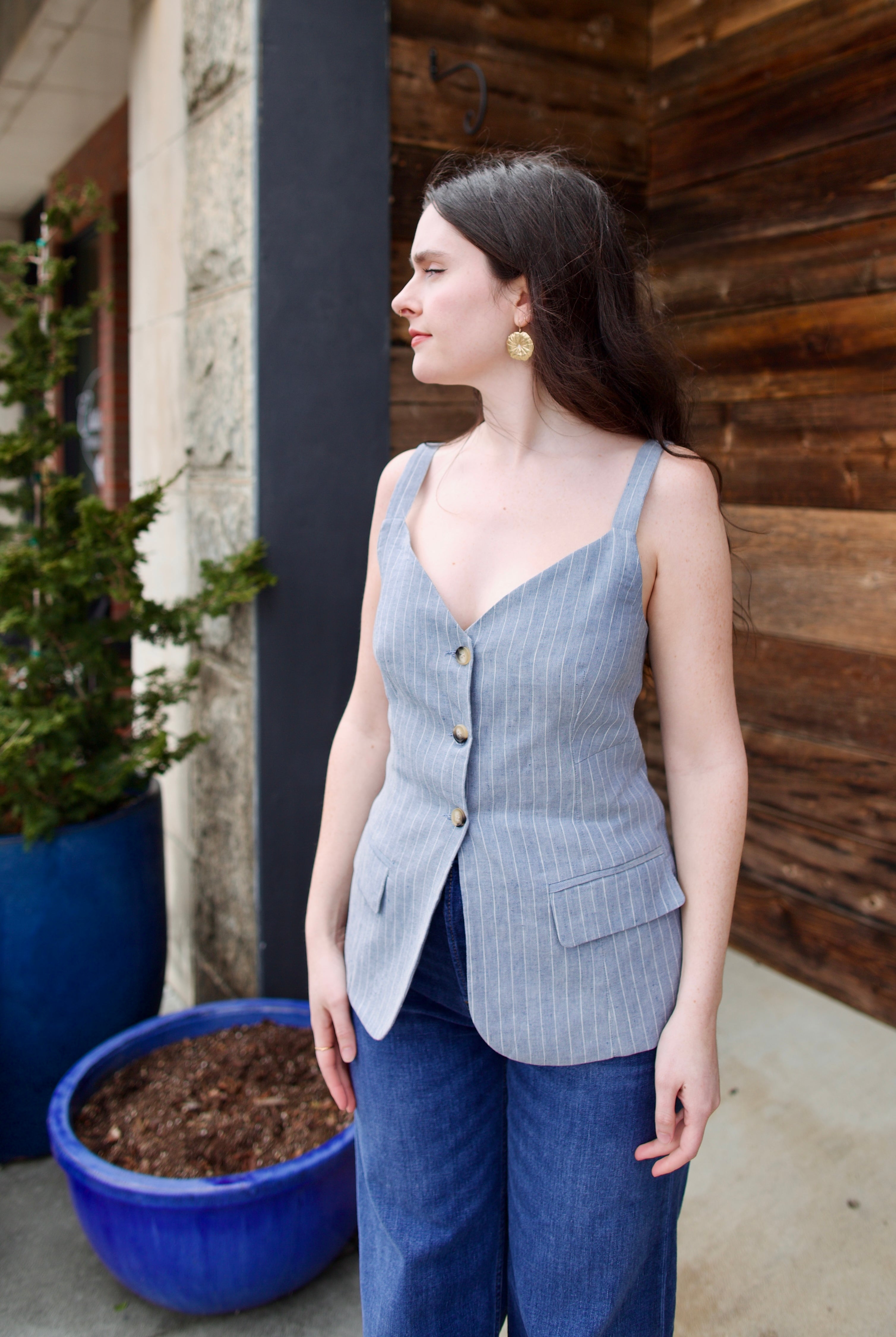 Woman wearing the Vanessa Bruno Elai Top V neckline with thin straps and tailored fit for timeless elegance and expert Parisian craftsmanship