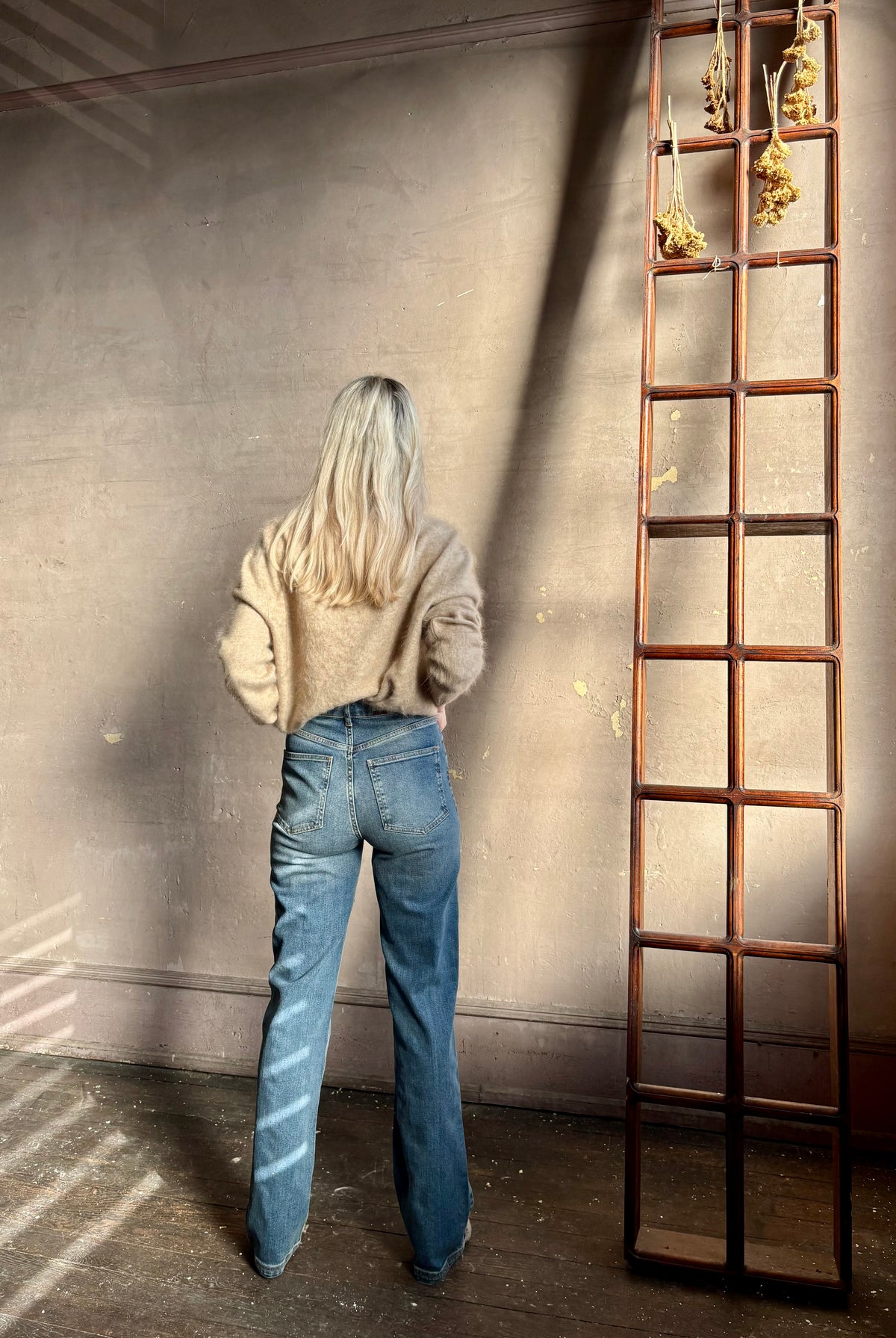 Back image of woman wearing Vanessa Bruno Benito jeans button and zip closure high rise straight leg full length medium wash