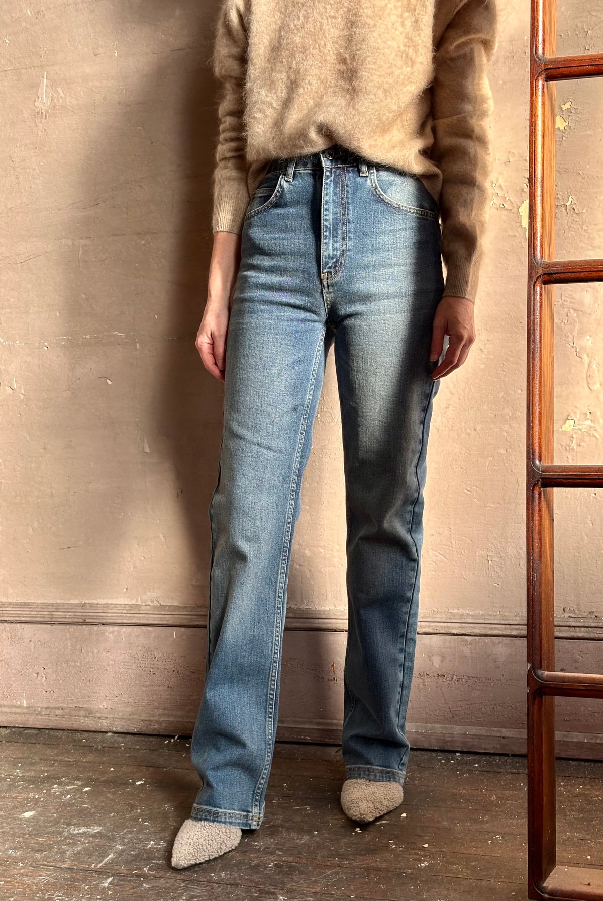 Mature woman wearing French made straight-leg cotton jeans by Vanessa Bruno high waisted in medium wash full length