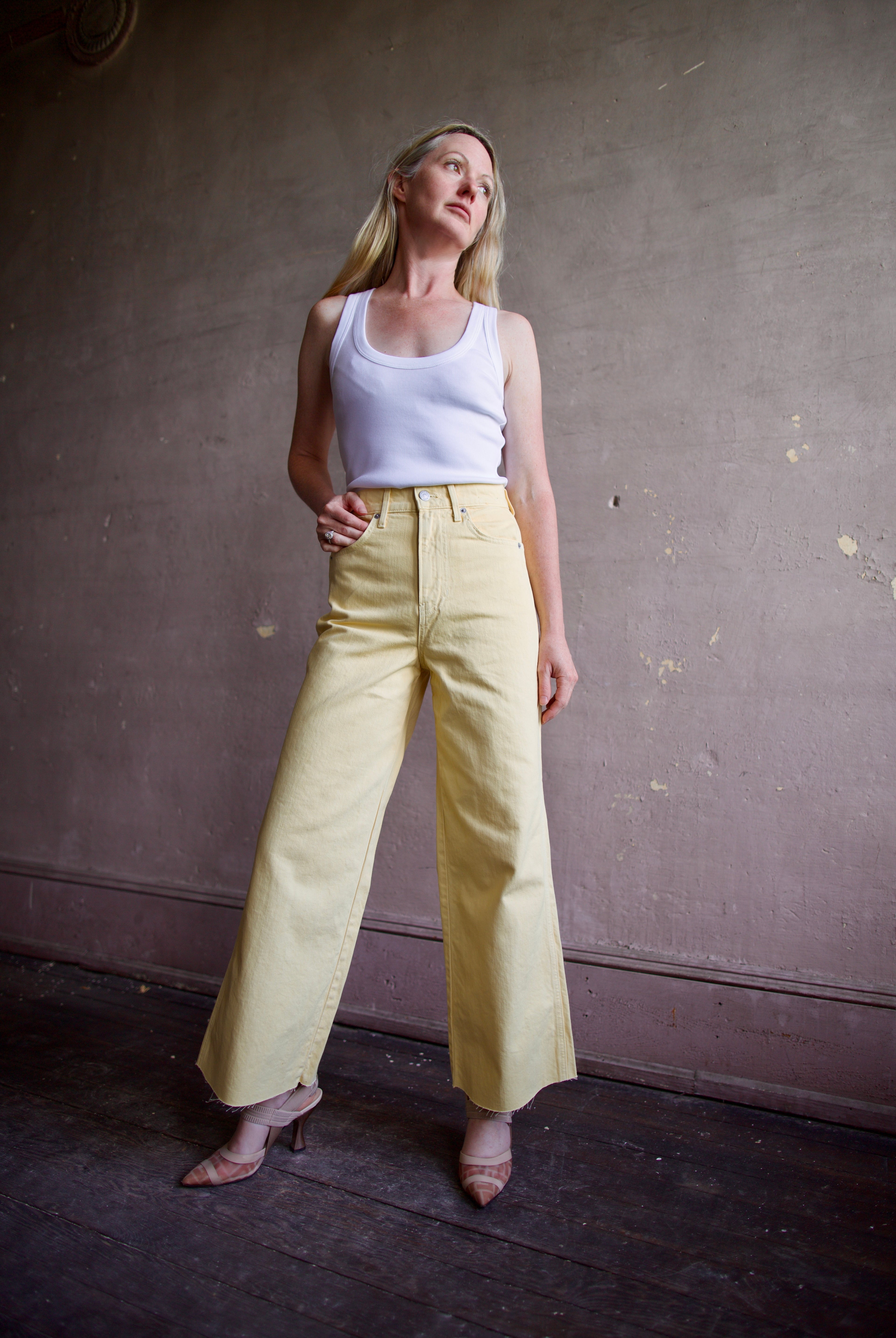 Image of a model wearing designer Veronica Beard butter yellow high rise crop taylor denim
