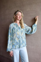 Image of model wearing premium designer Veronica Beard Fennel Pleated Blouse with long sleeve Bohemian style