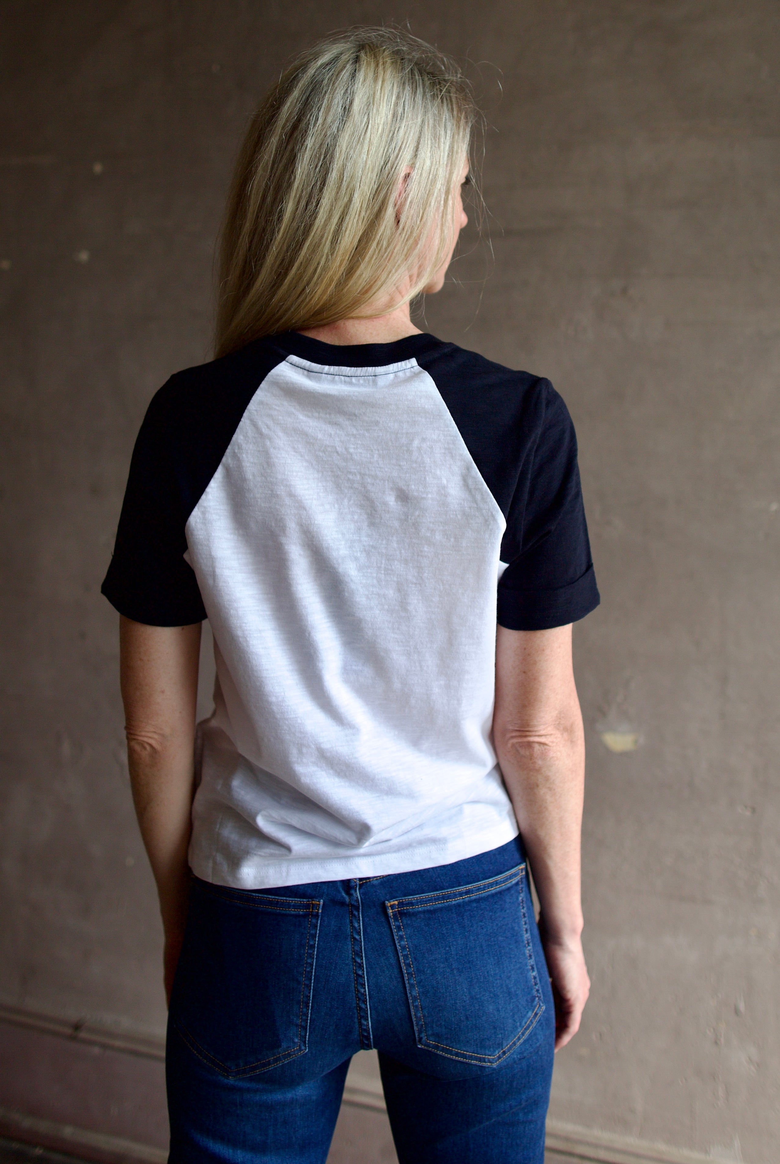 Back image of a woman wearing the Veronica Beard Mason Baseball Tee and Beverly Jeans