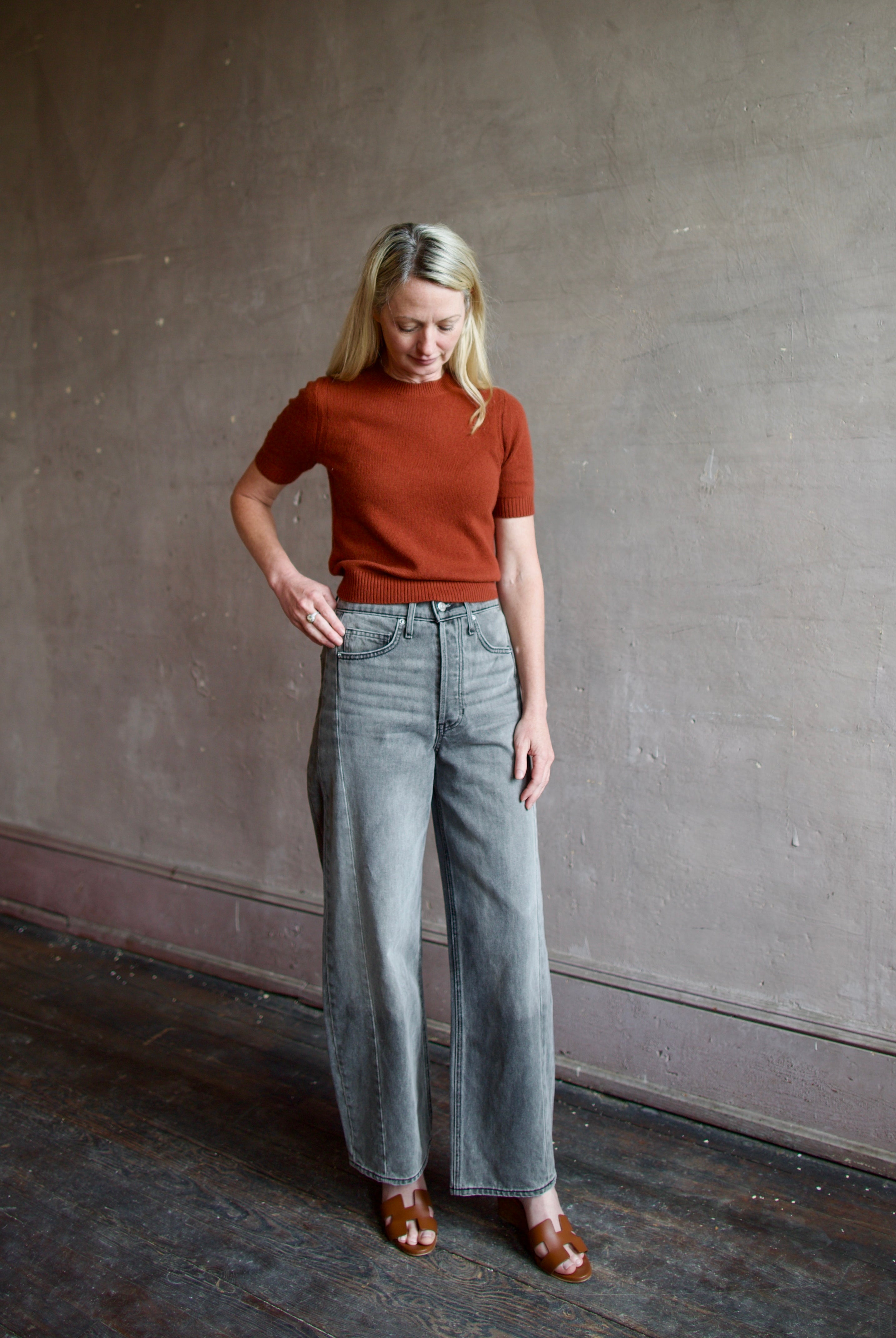 Mature model wearing designer brand Veronica Beard high rise Ryder grey barrel denim fabricated with rigid cotton