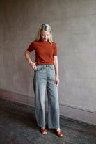 Mature model wearing designer brand Veronica Beard high rise Ryder grey barrel denim fabricated with rigid cotton