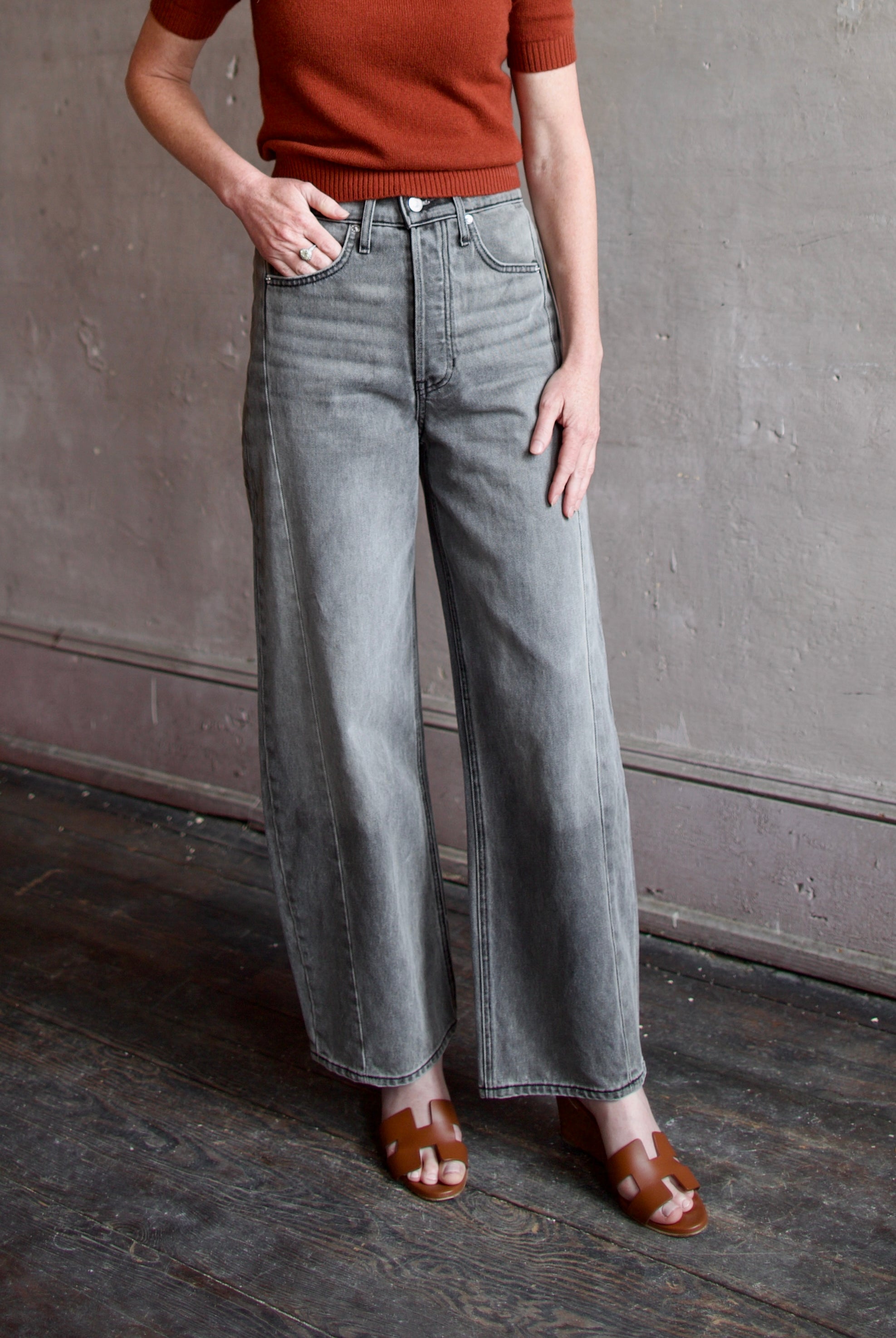 Mature model wearing designer brand Veronica Beard high rise Ryder grey barrel denim fabricated with rigid cotton