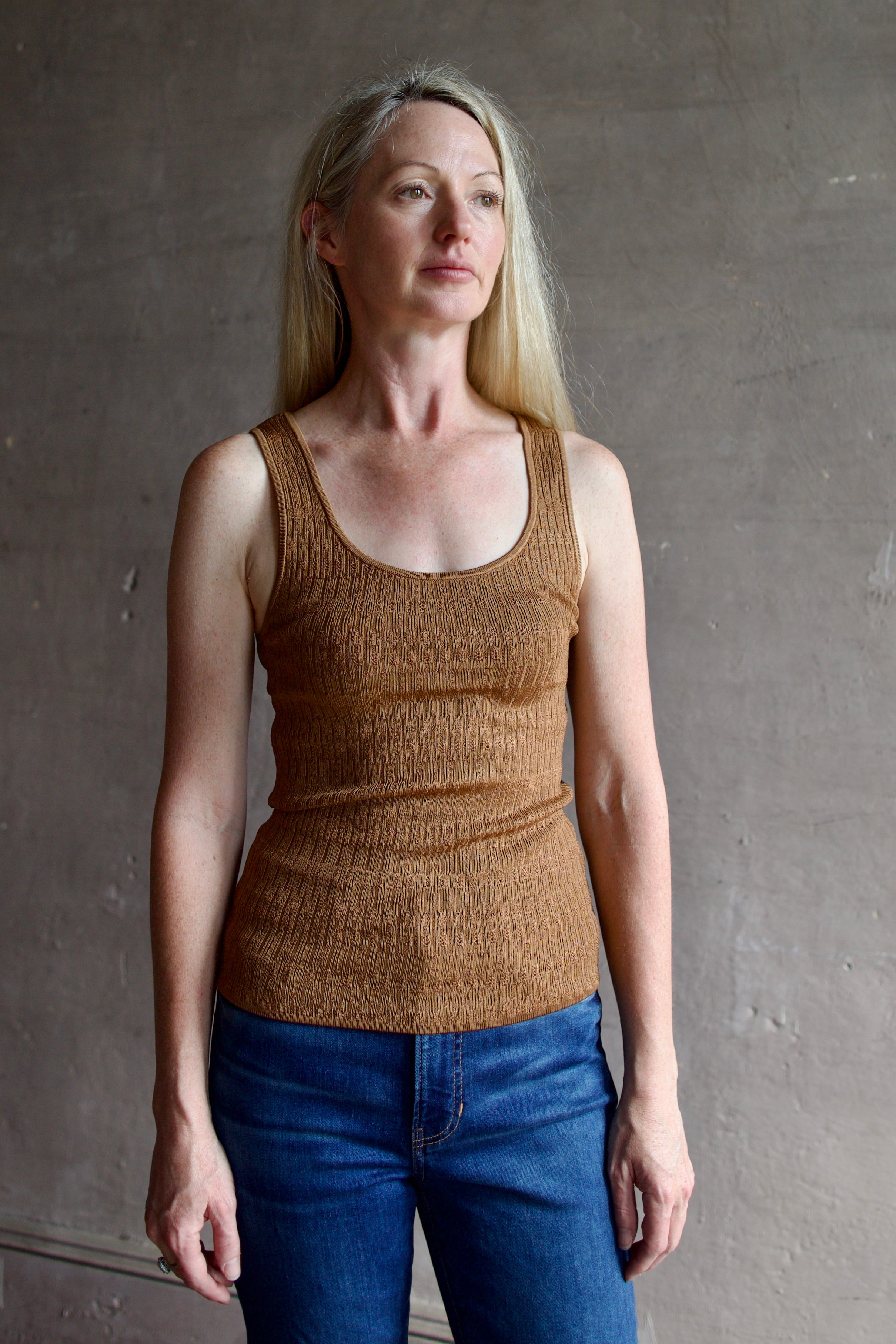 Model wearing premium  designer Veronica  Beard Sandra Tank with quality texture and scoop neck in a neutral copper colorway
