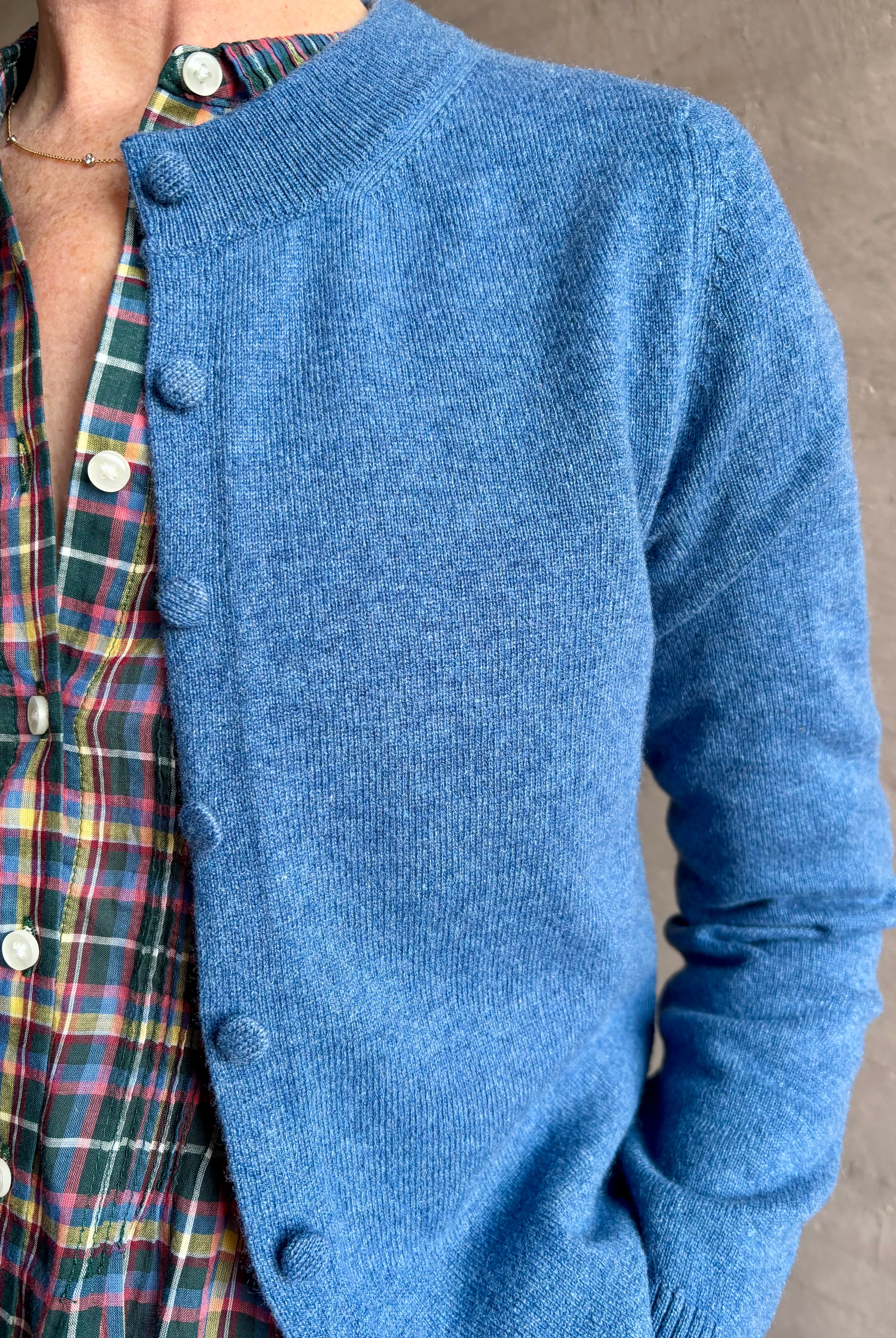 woman wearing designer Veronica Beard Daro Cashmere Cardigan in Blue Coast Melange with long sleeves and covered fabric buttons