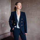Image featuring a woman wearing the Veronica Beard Miller Dickey Jacket with Gold Buttons in Navy blue.