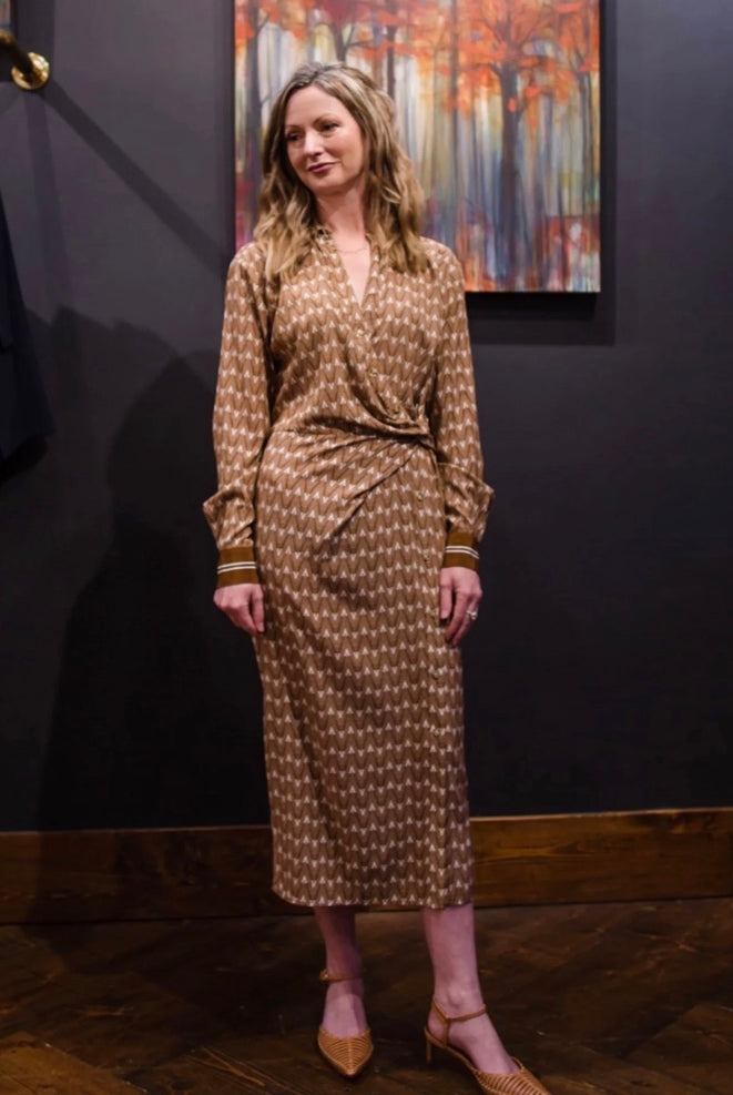 Image featuring a woman wearing the Wright wrap dress by Veronica Beard with a twist detail at the waist.