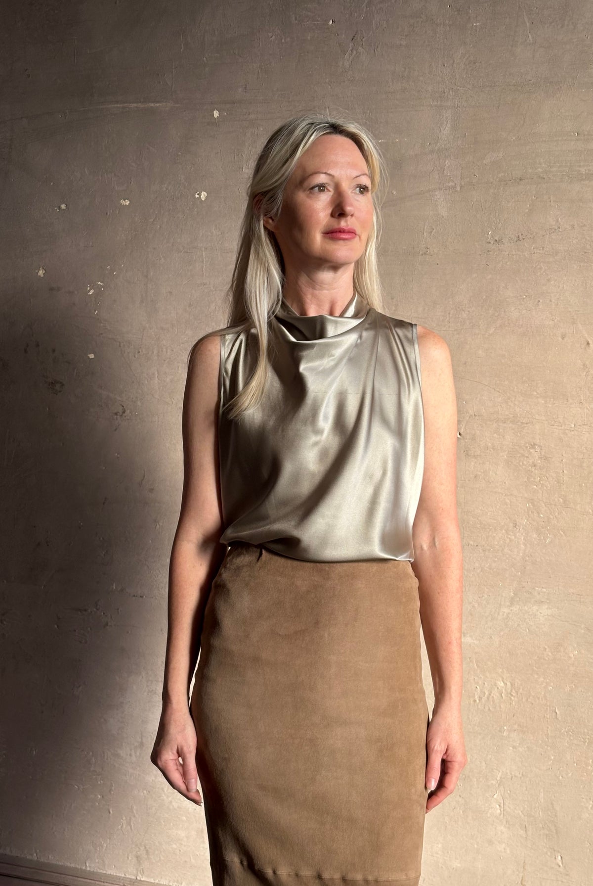 Mature woman wearing Veronica Beard Tam Top in Pewter silk blend waterfall neckline and sleeveless with fluid draping perfect for luxury layering options