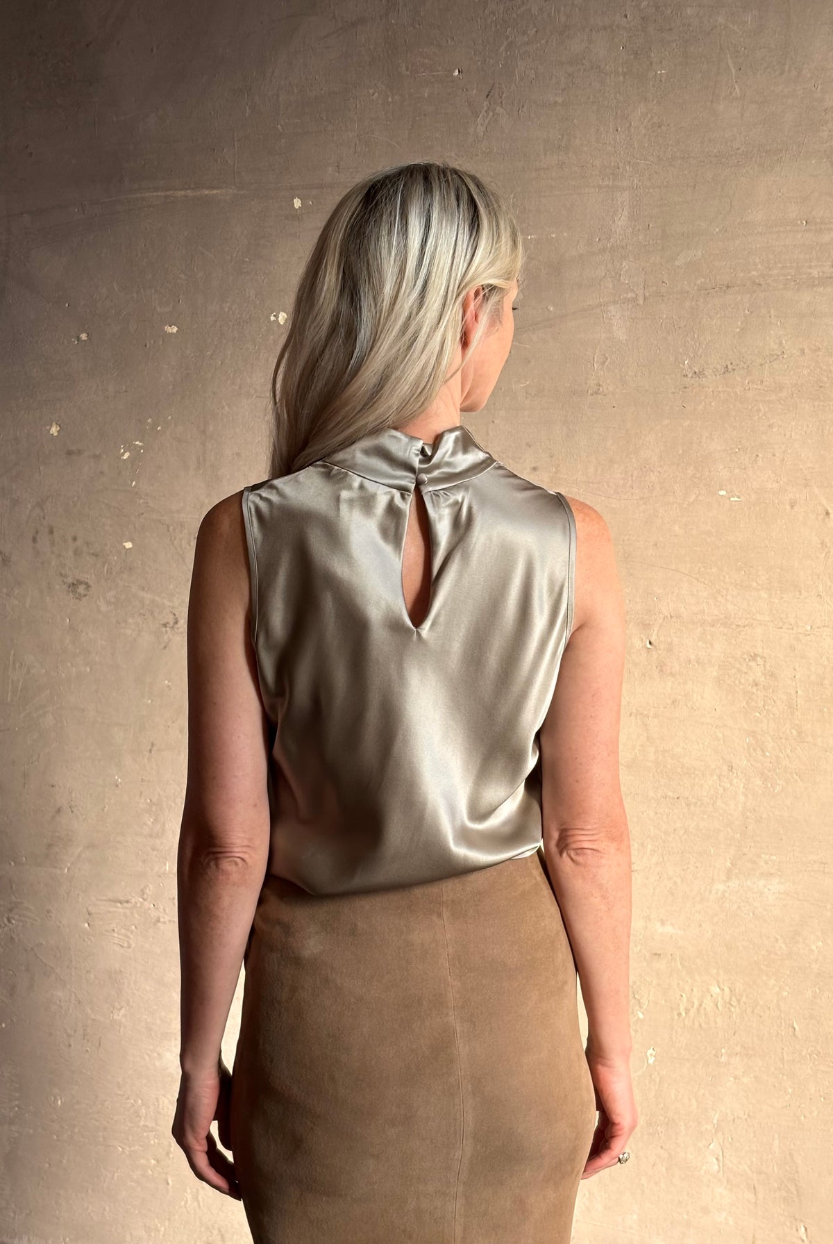 Mature woman wearing Veronica Beard Tam Silk Top in Pewter silk blend fabric-covered keyhole button back closure sleeveless