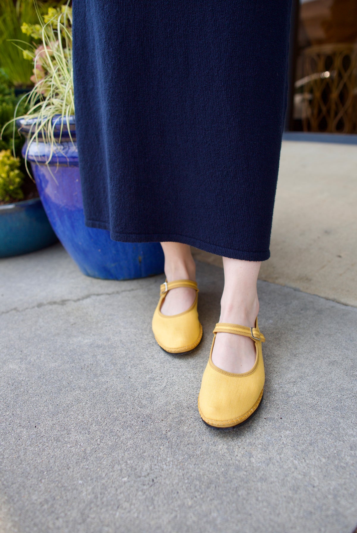 A pair of yellow Vibi Venezia slippers with yellow grosgrain ribbon trim in premium linen construction and traditional Mary Jane design