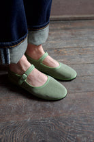 Image of  model wearing Vibi Venezia mint green velvet mary jane's worn with rolled-up jeans