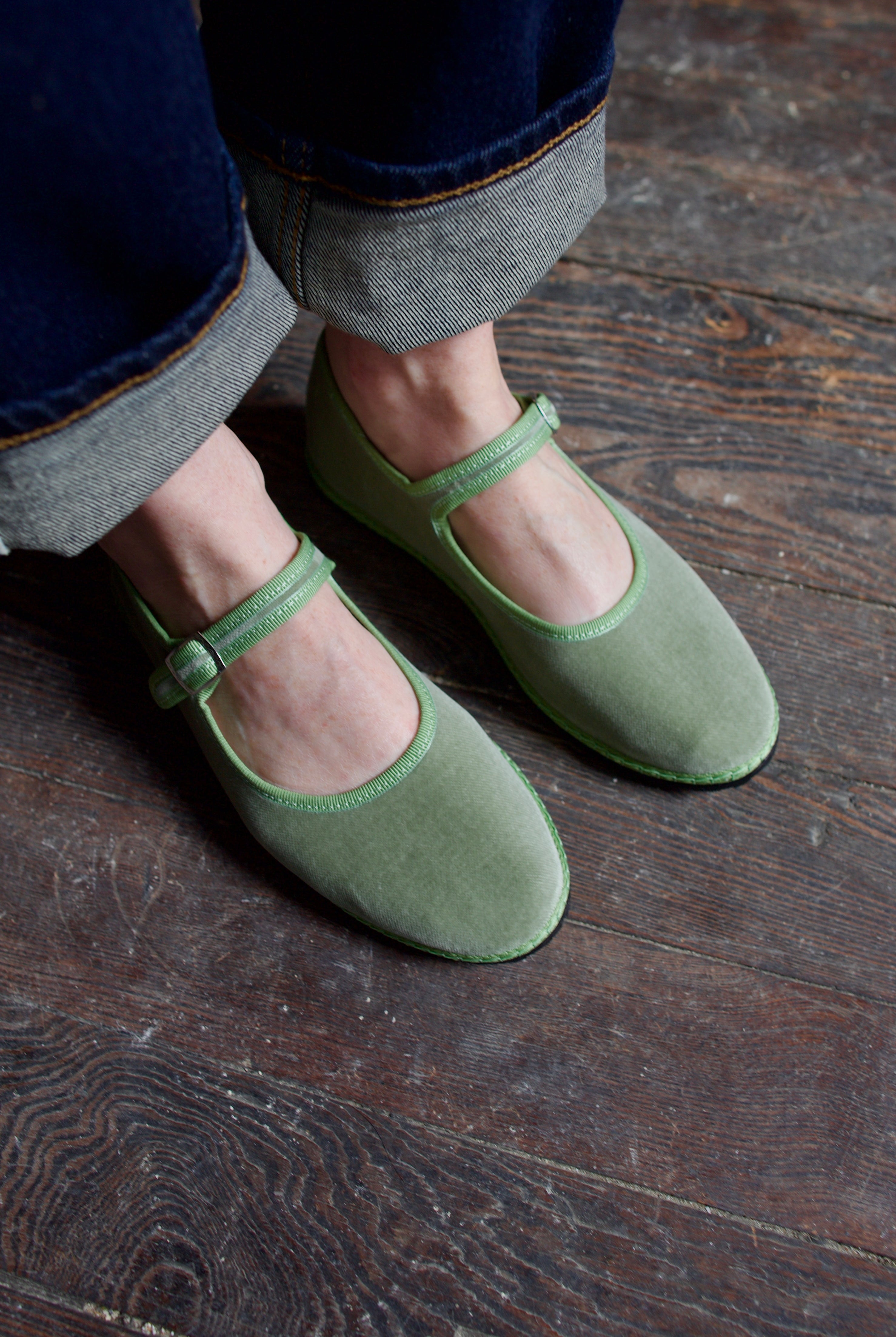 Image of  model wearing Vibi Venezia mint green velvet mary jane's worn with rolled-up jeans
