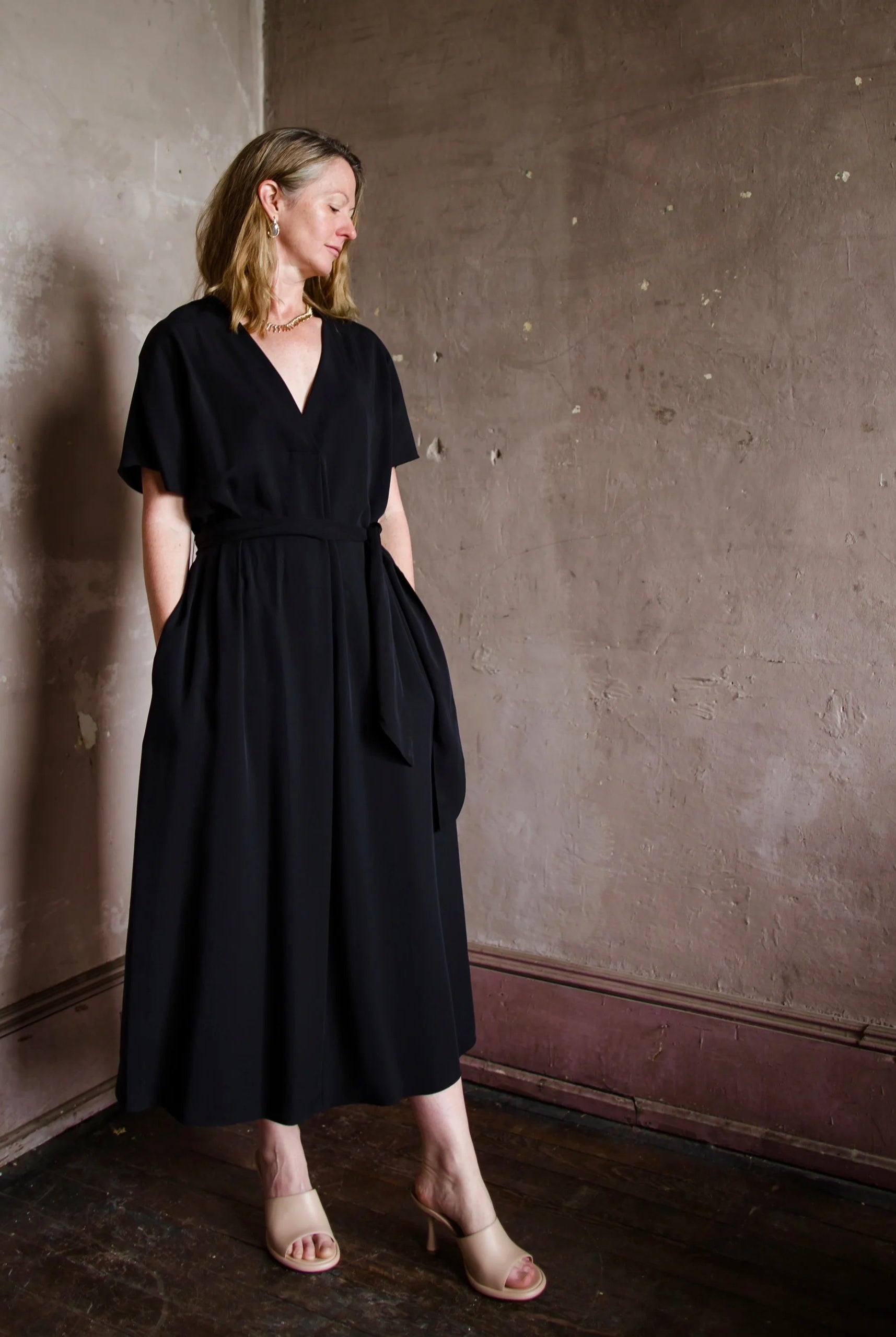 Image featuring a woman wearing the Vince Black Belted A-Line Dress for the ultimate quiet luxury look.