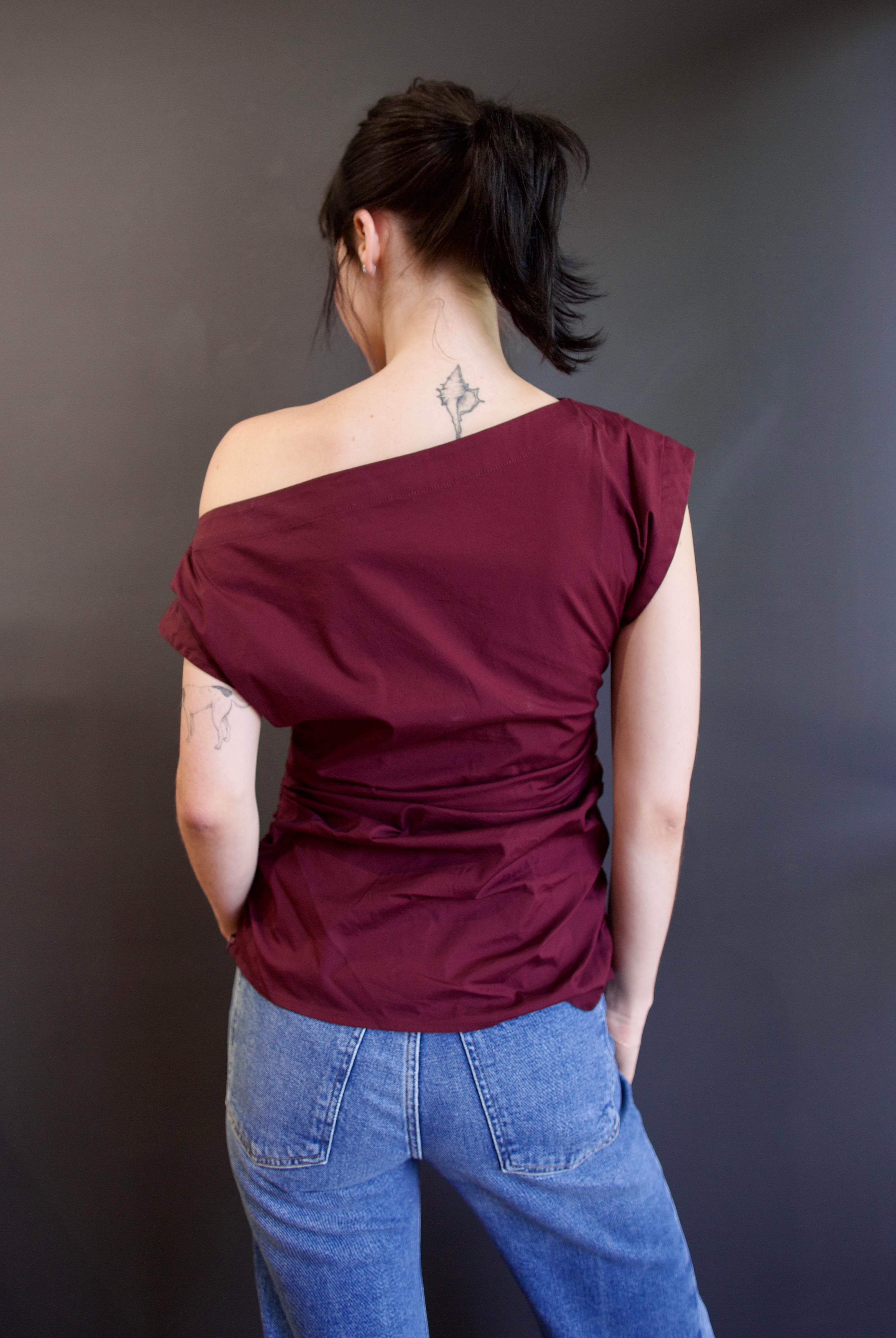 Back of ALC Nara top in burgundy with one-shoulder asymmetrical design and rushing at waistline