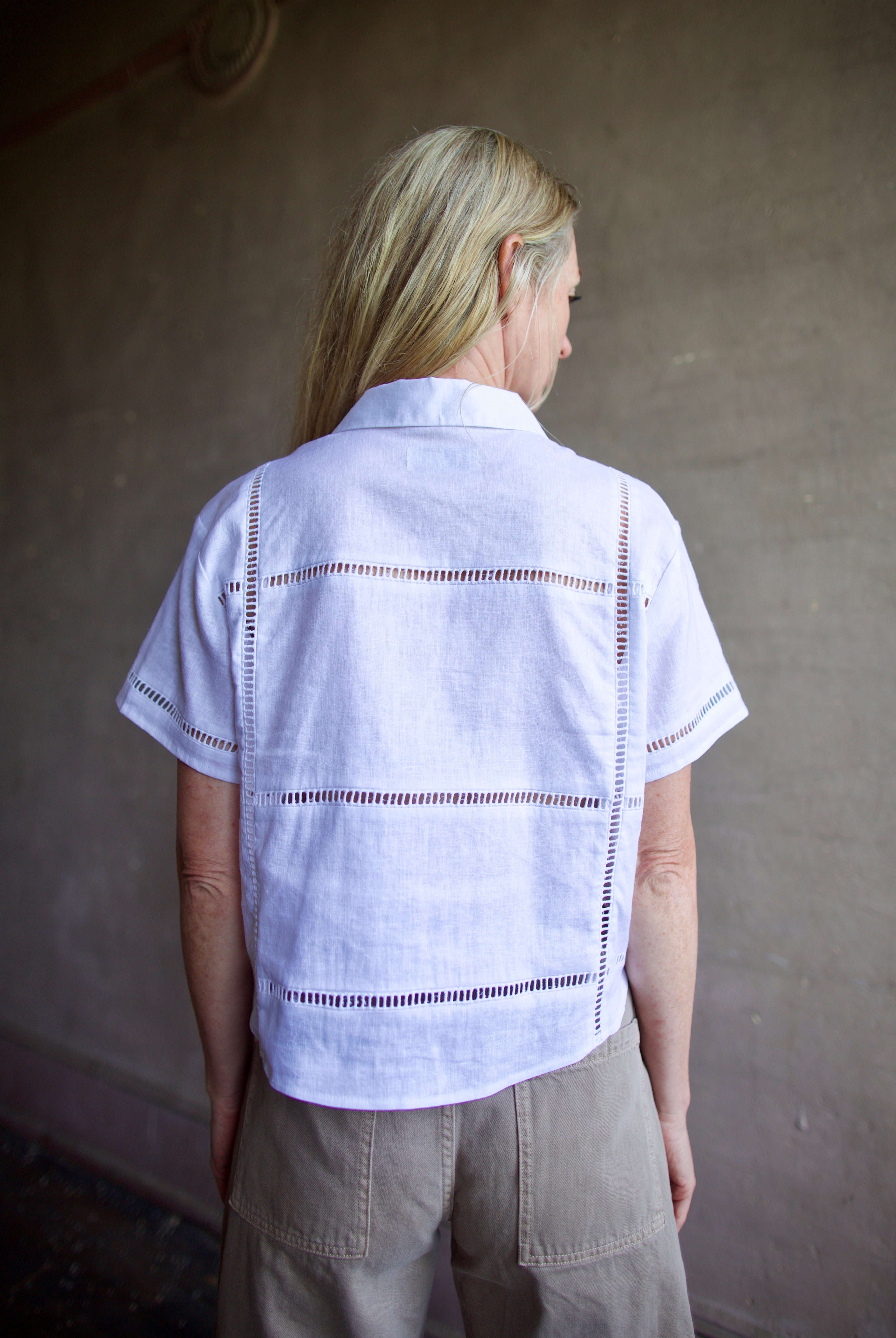 Image of a model wearing the Le Jean Linen Eyelet Shirt in classic button front design for a timeless closet staple