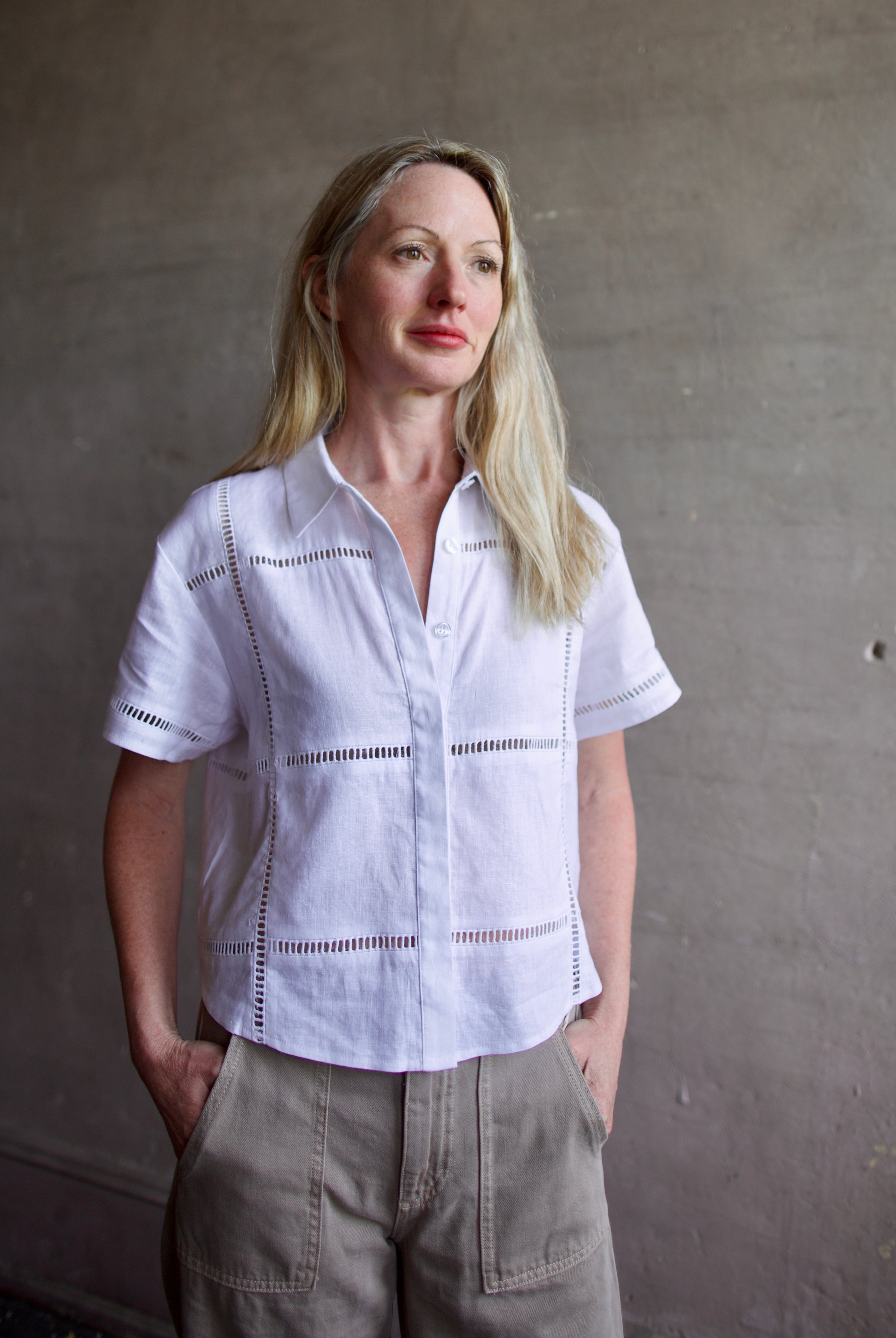 Image of a model wearing the Le Jean Linen Eyelet Shirt in classic button front design for a timeless closet staple
