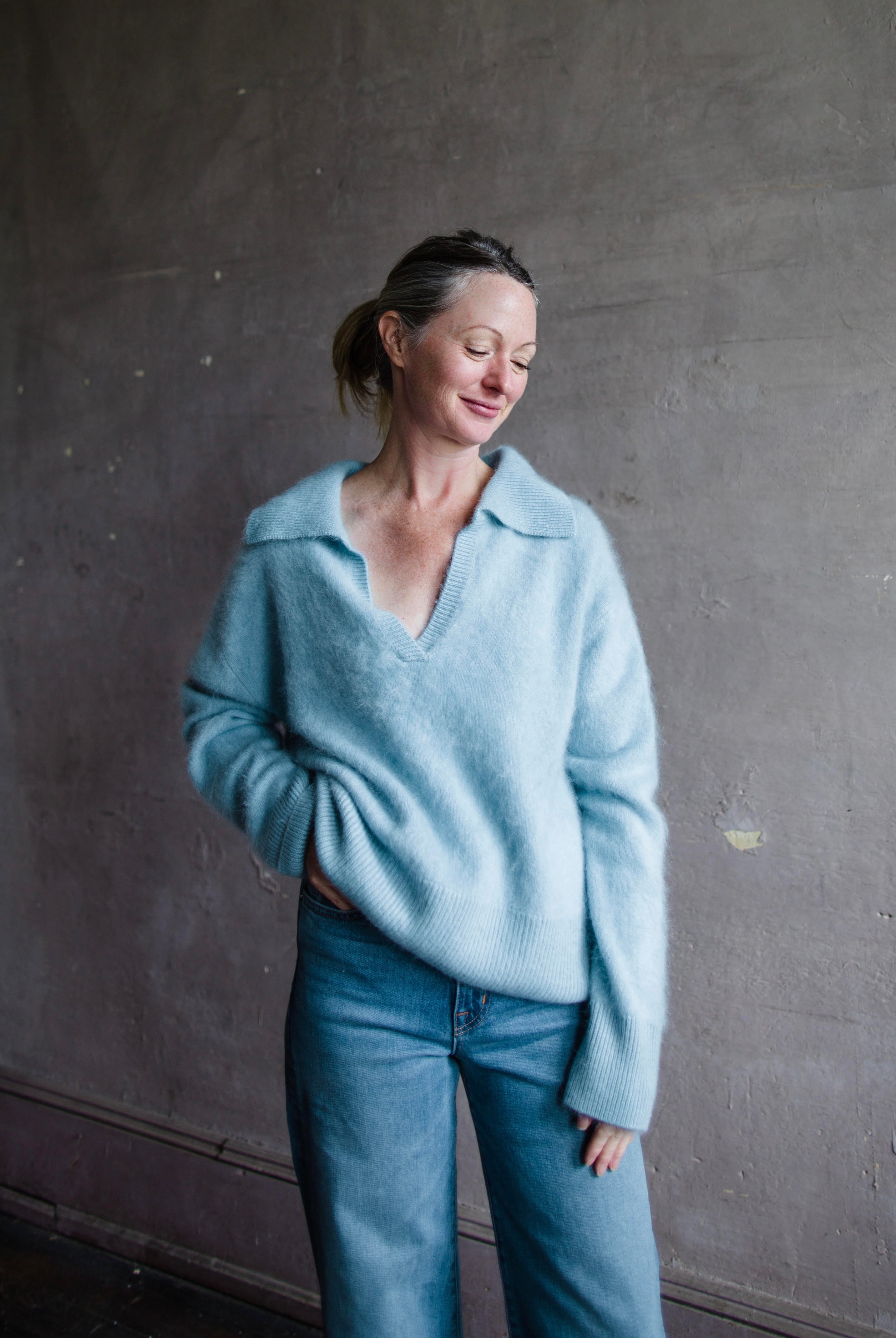 Image featuring a woman wearing the Kerry sweater by Lisa Yang with a v neckline and collar in the softest powder blue brushed cashmere.
