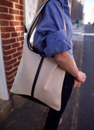 Soeur Delice luxury women's bag featuring top handle with snap closure, textured cotton, and black leather trim