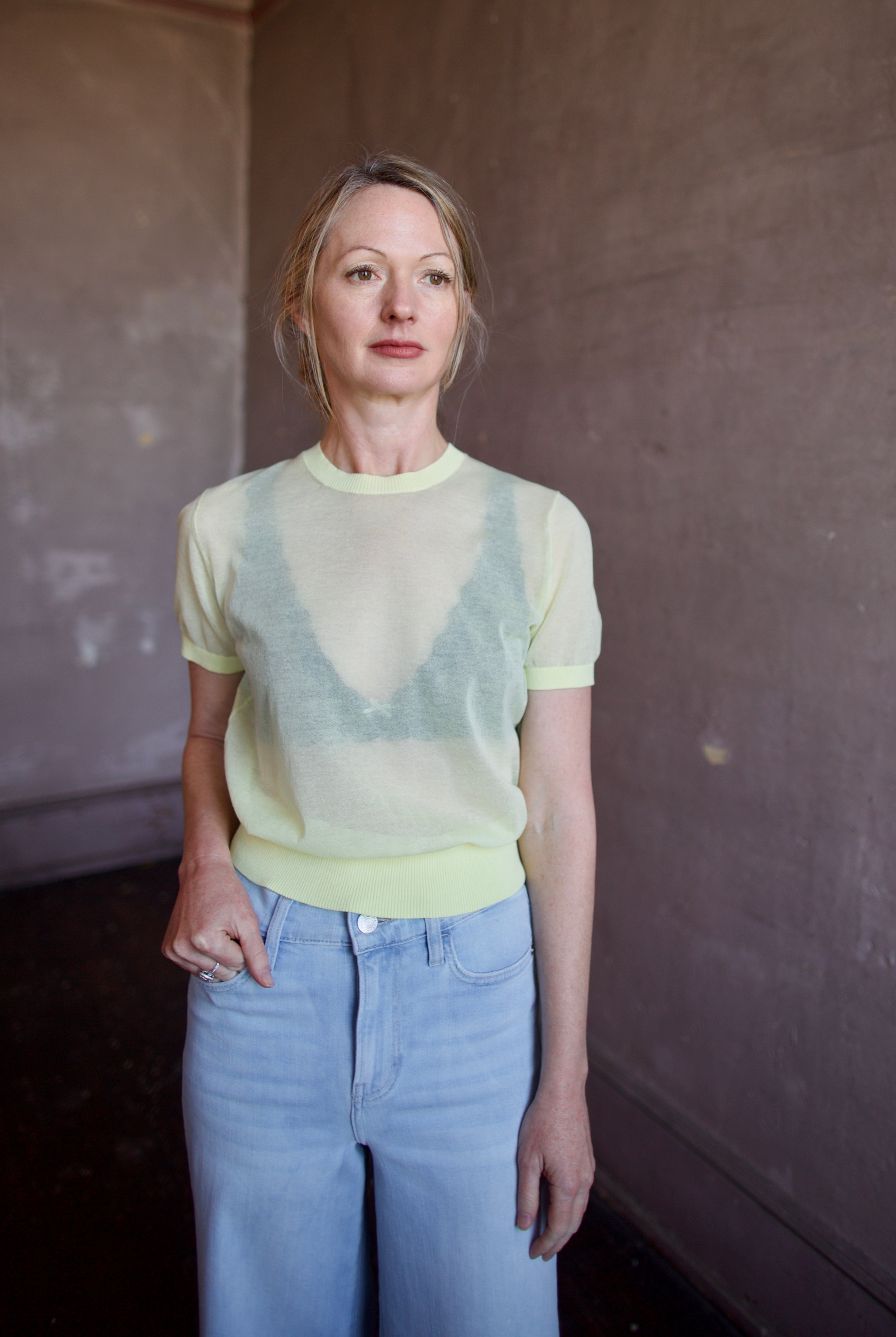Image of a woman wearing the Soeur Dua Sheer Pullover and Frame Palazzo Jeans