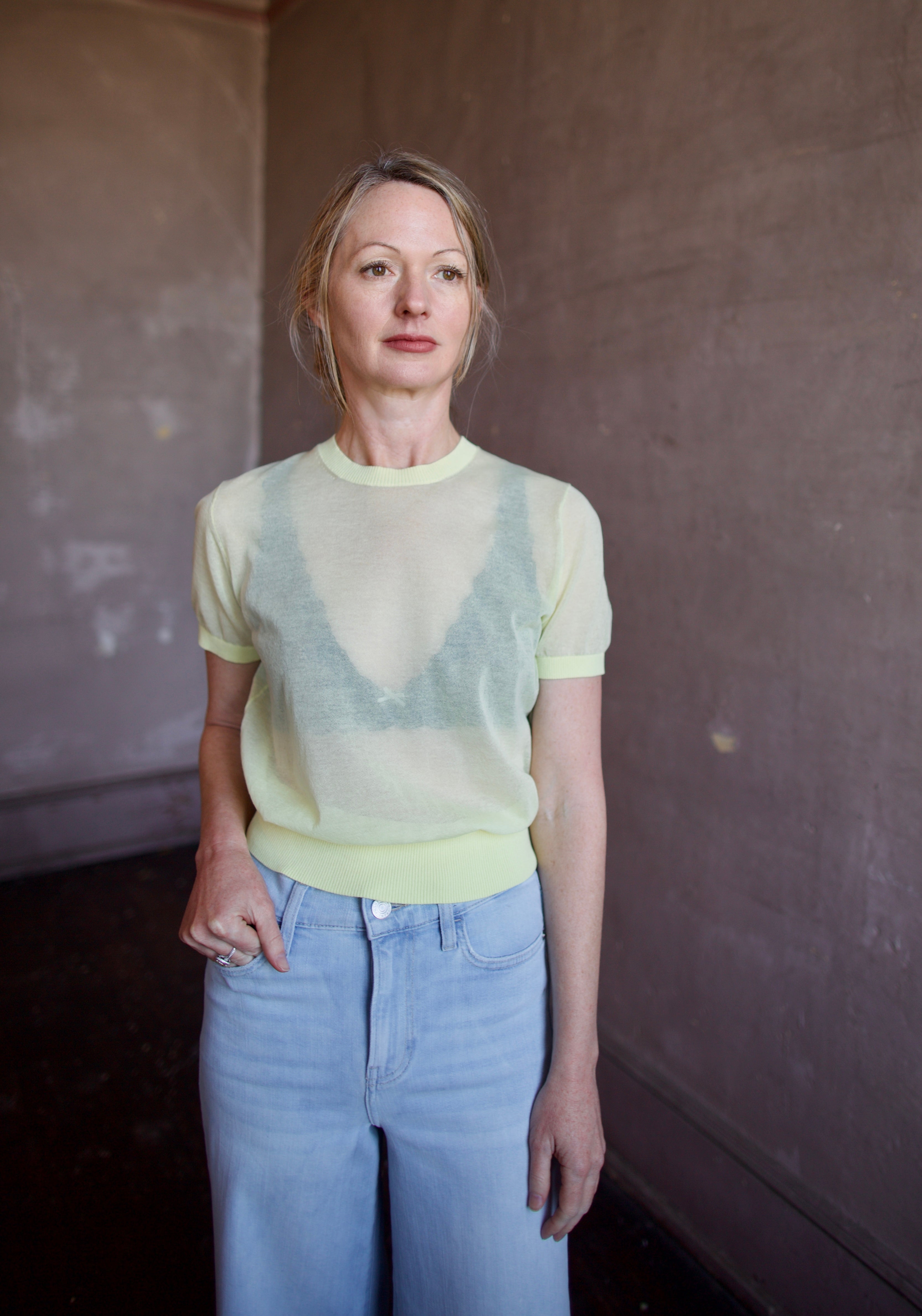Image of a woman wearing the Soeur Dua Sheer Pullover and Frame Palazzo Jeans