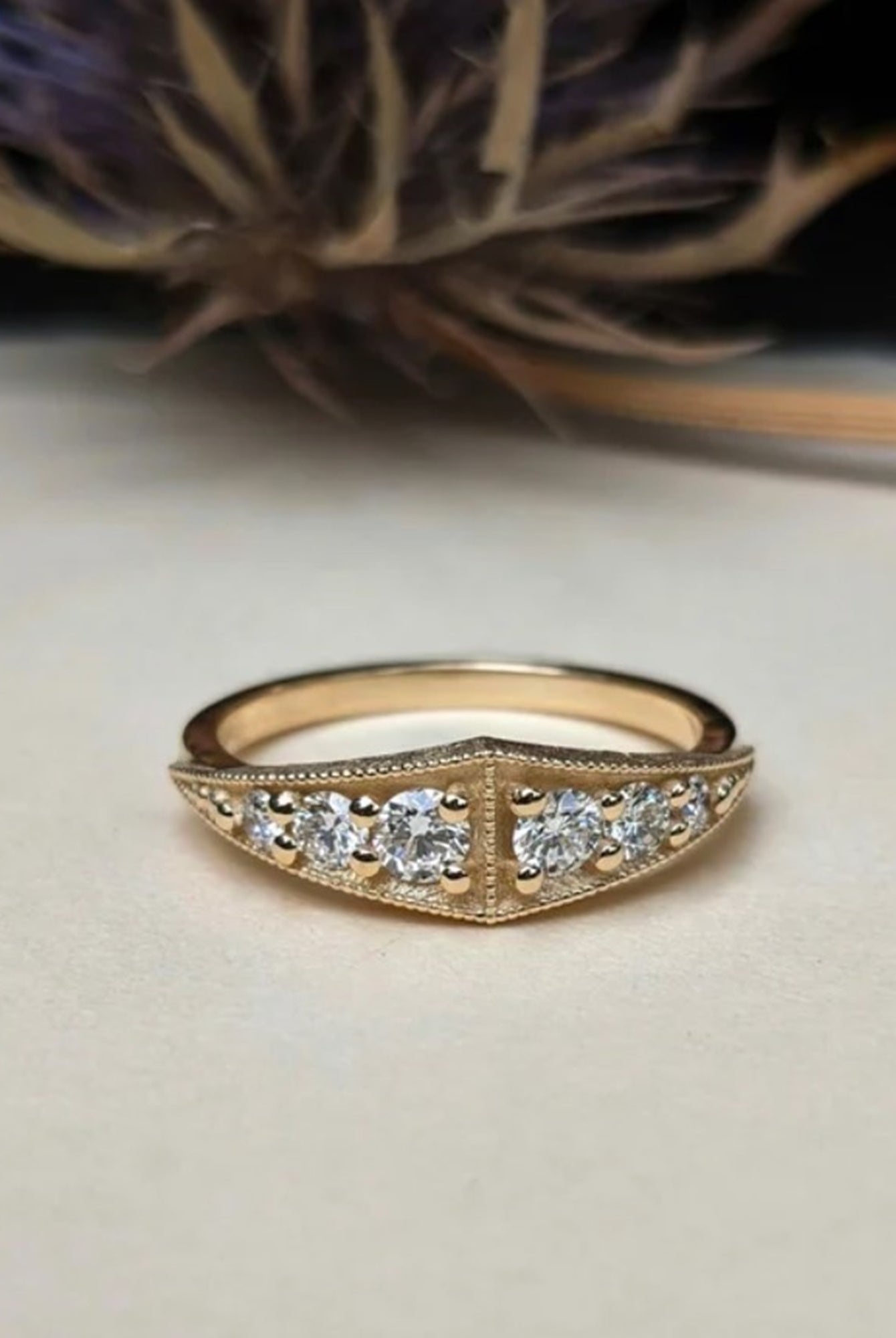 Image of American jeweler Stephanie Ellis 14k yellow gold band ring with six graduating round brilliant diamonds in a vintage style with a modern twist