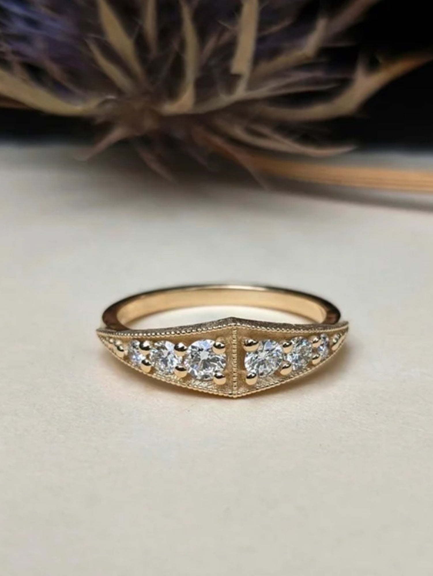 Image of American jeweler Stephanie Ellis 14k yellow gold band ring with six graduating round brilliant diamonds in a vintage style with a modern twist
