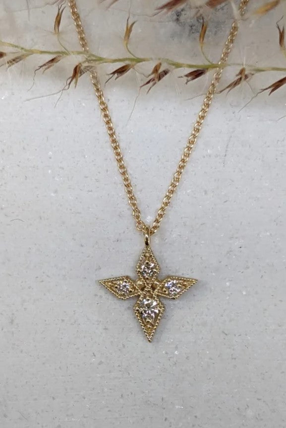 Image of Asheville artist Stephanie Ellis 14kt yellow gold necklace featuring a star-shaped pendant adorned with round brilliant natural diamonds.