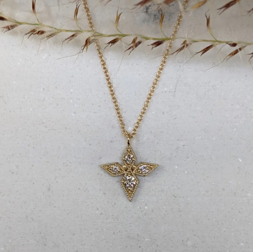 Image of Asheville artist Stephanie Ellis 14kt yellow gold necklace featuring a star-shaped pendant adorned with round brilliant natural diamonds.