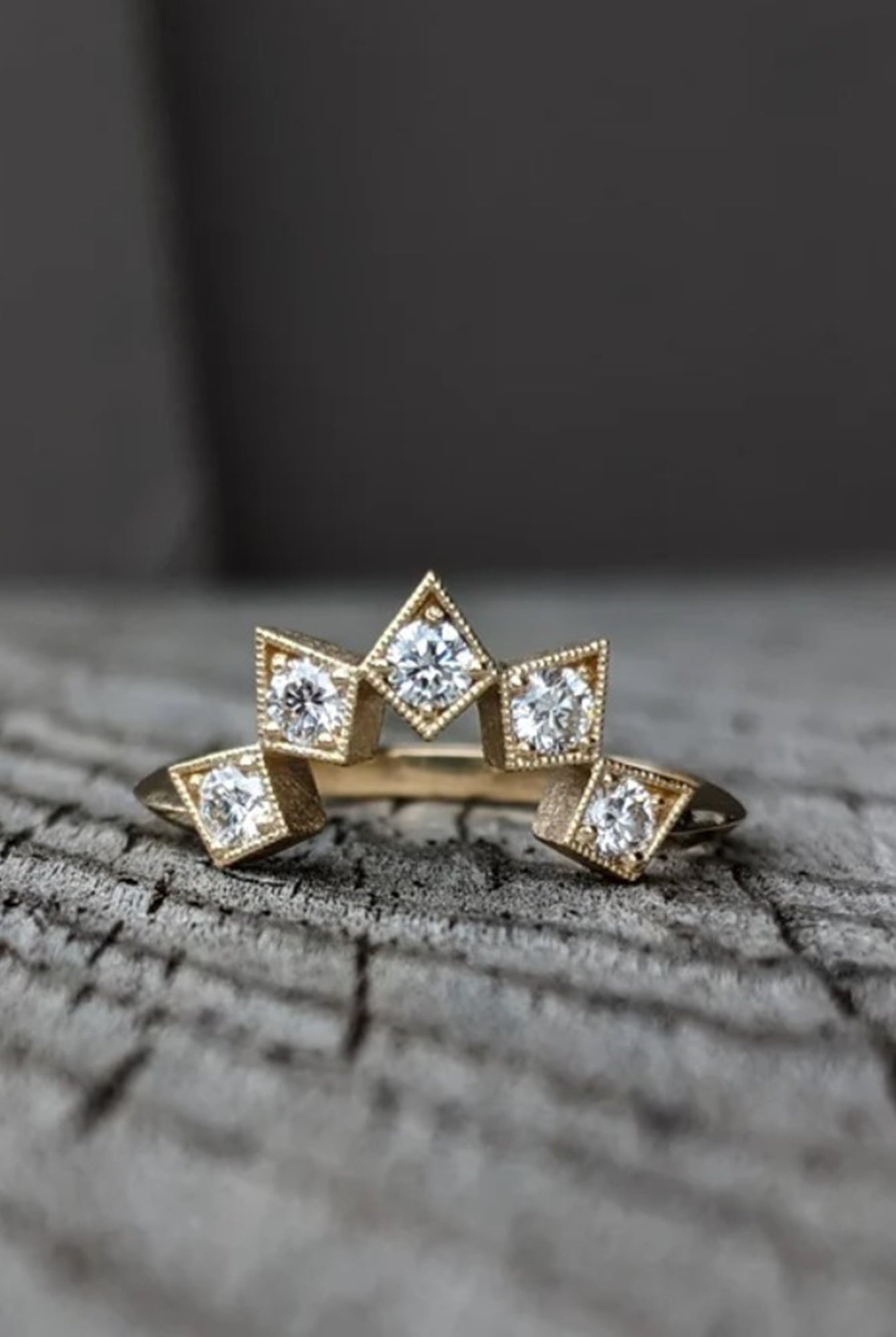 Image of North Carolina artist Stephanie Ellis 14k yellow gold band ring with six premium round brilliant natural diamonds set in it a star-inspired configuration