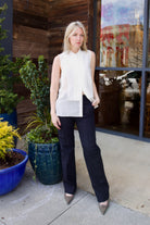 Mature woman wearing luxury brand TWP Adele top with button placket sequin detailing and tux-inspired design in premium silk cotton blend