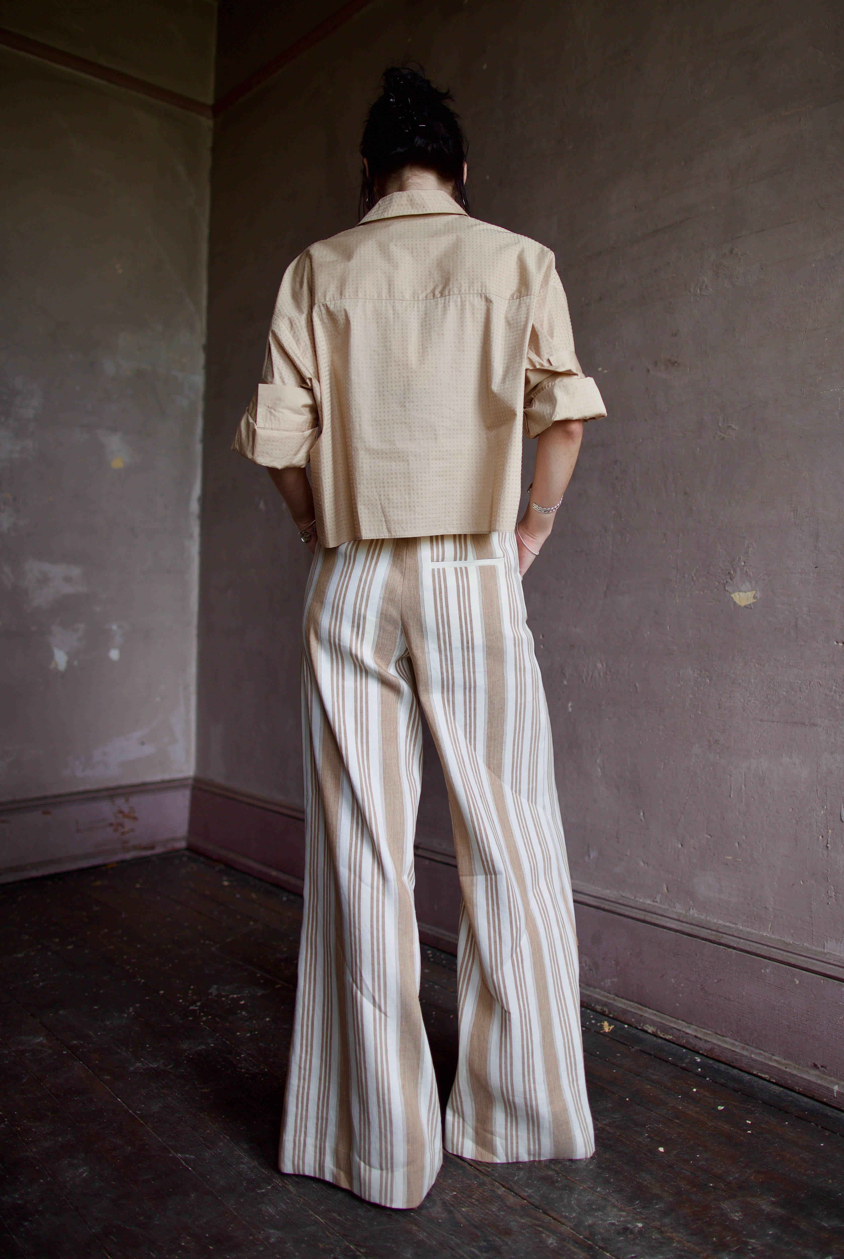 Back image of a woman wearing the TWP Next Ex with Crystals and the Demie Trousers without Pintucks