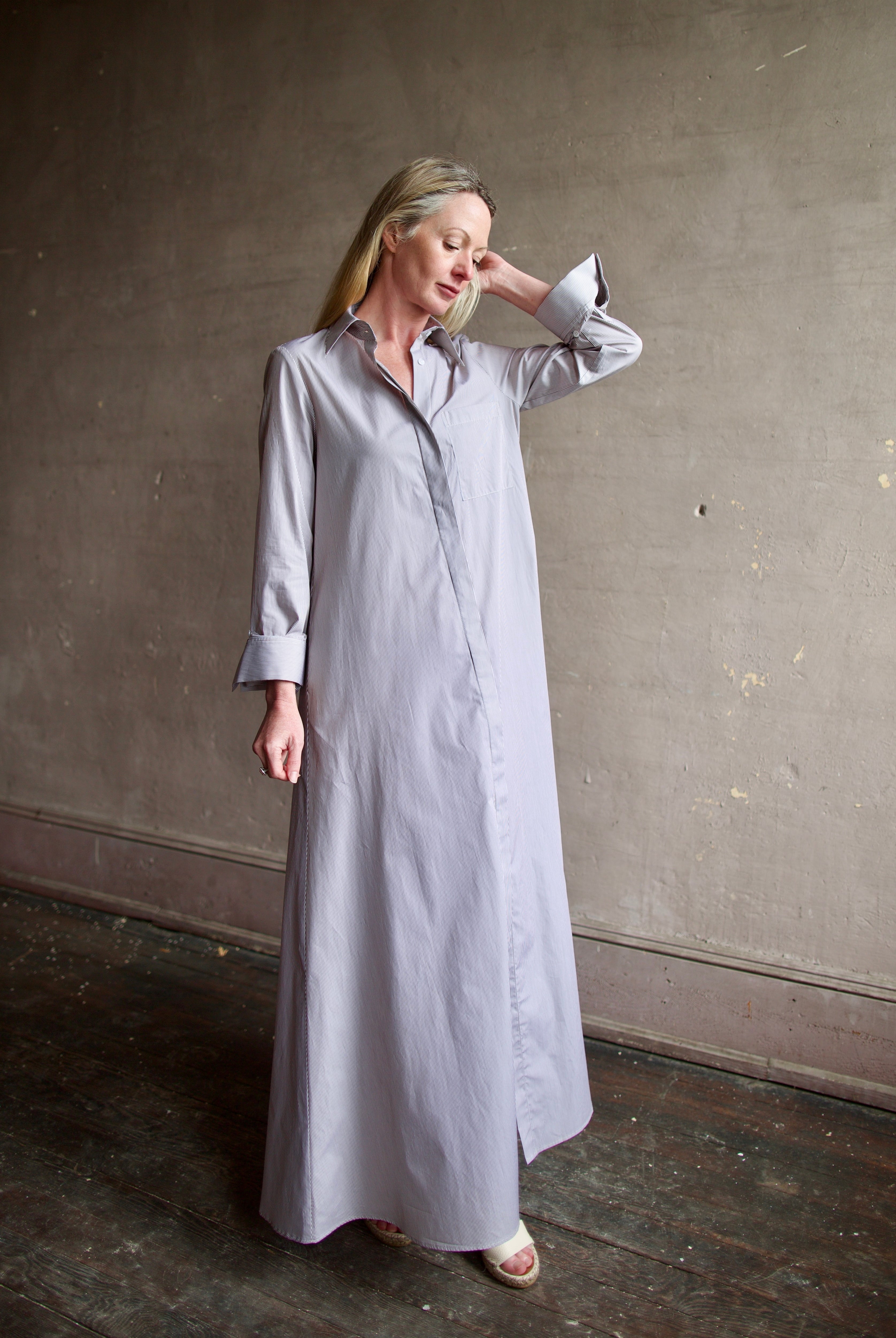 Model wearing luxury TWP Jenny's Gown in Brown Stripe effortless sophistication in a comfortable premium cotton