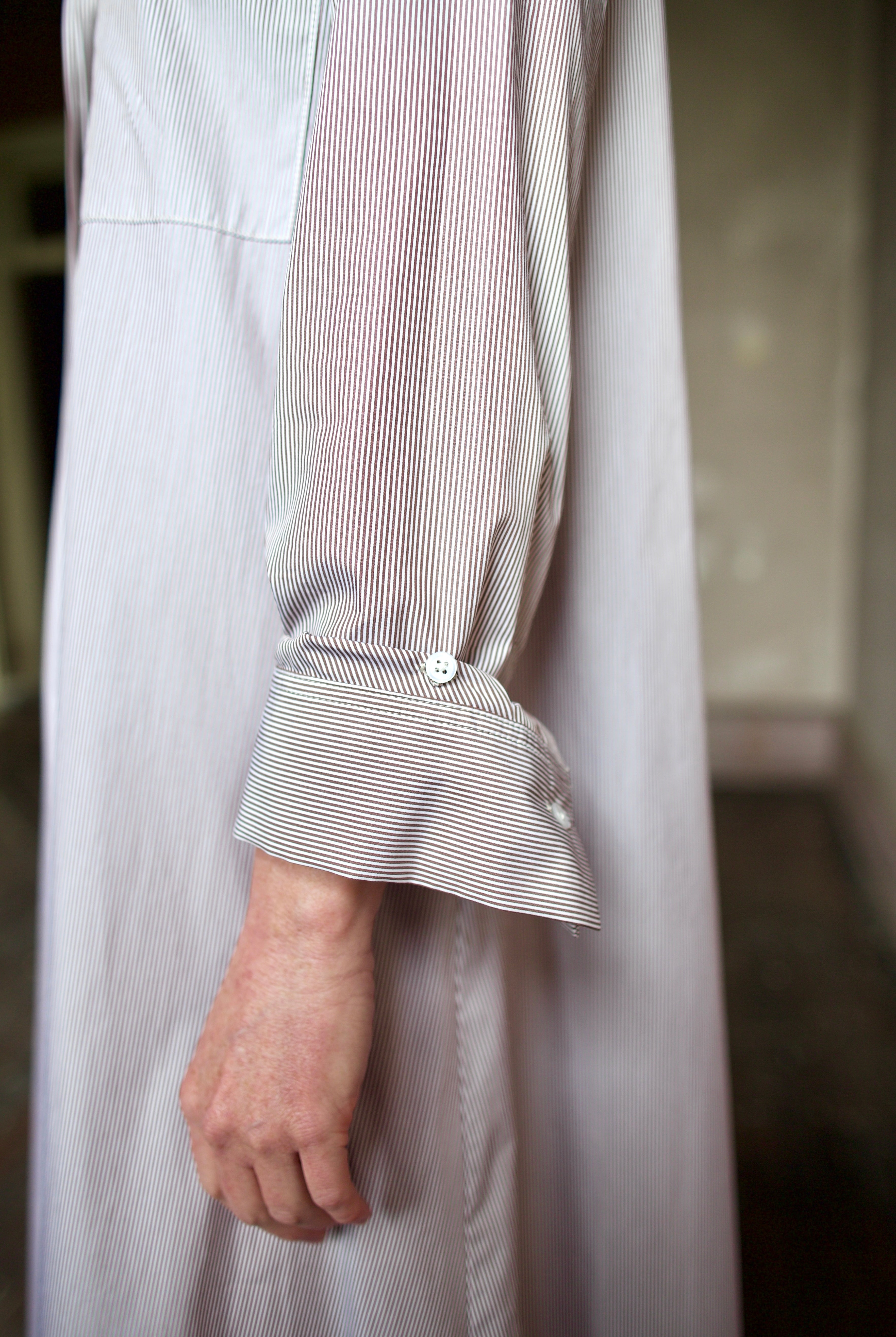 Detail image of model wearing the TWP Jenny's Gown in Brown Stripe showing sleeve detail