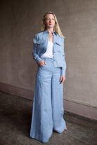 Image of model wearing luxury TWP New Carter indigo Button Up hemp top combining timeless workwear with contemporary refinement