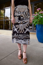 Model wearing luxury designer Ulla Johnson lightweight cotton Mila Pencil wrap Skirt in ikat black and purple colorway with pocket