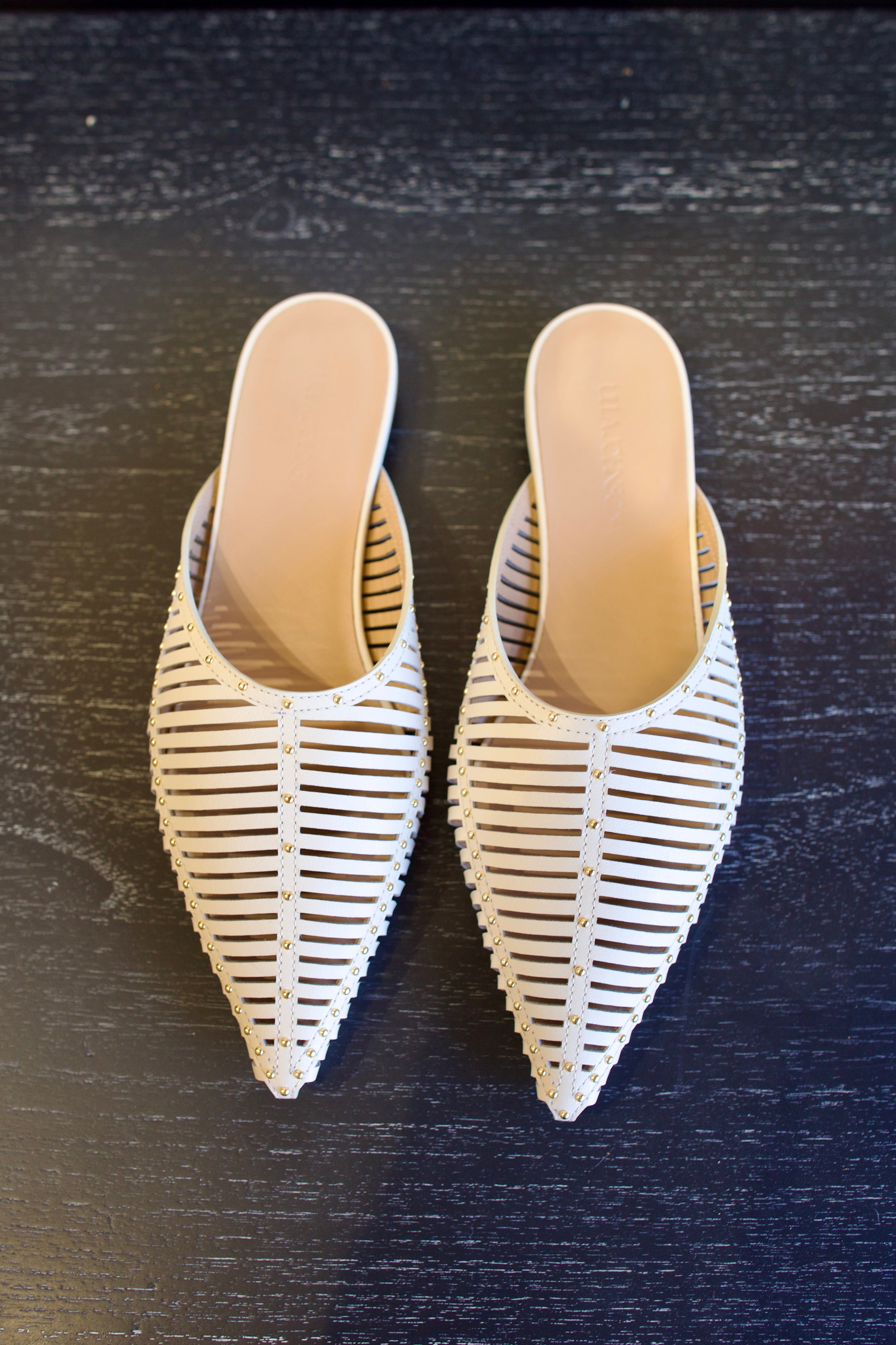Image of white Ulla Johnson Octavia Mule shoe with gold studs slip on premium leather shoe with pointed toe