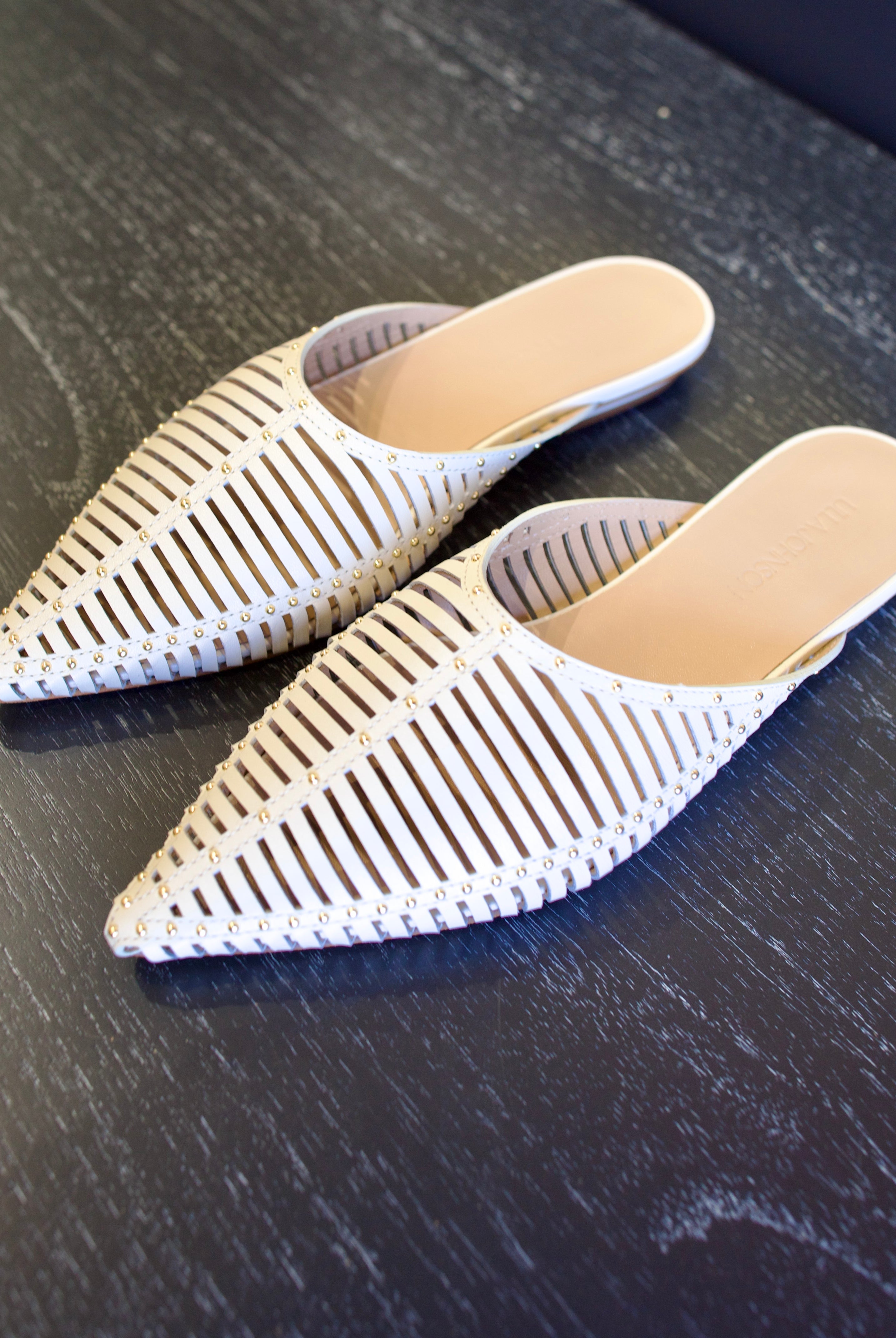 Image of white Ulla Johnson Octavia Mule shoe with gold studs slip on premium leather shoe with pointed toe