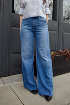 Image of a woman wearing Veronica Beard Kasey Jeans in luxury women's cotton lyocell denim with mid rise and wide leg silhouette