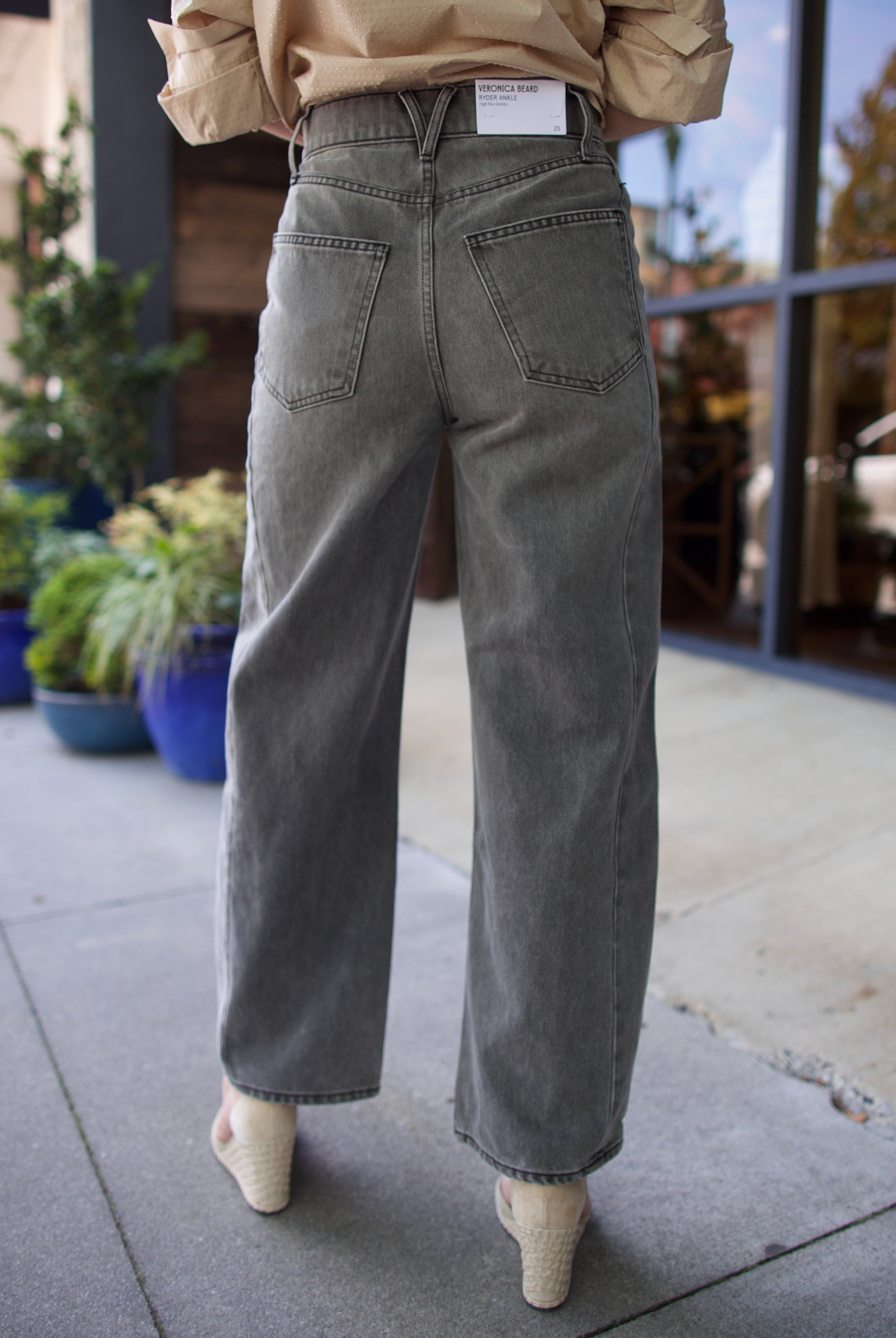 Mature model wearing designer brand Veronica Beard high rise Ryder grey barrel denim fabricated with rigid cotton
