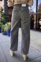 Mature model wearing designer brand Veronica Beard high rise Ryder grey barrel denim fabricated with rigid cotton